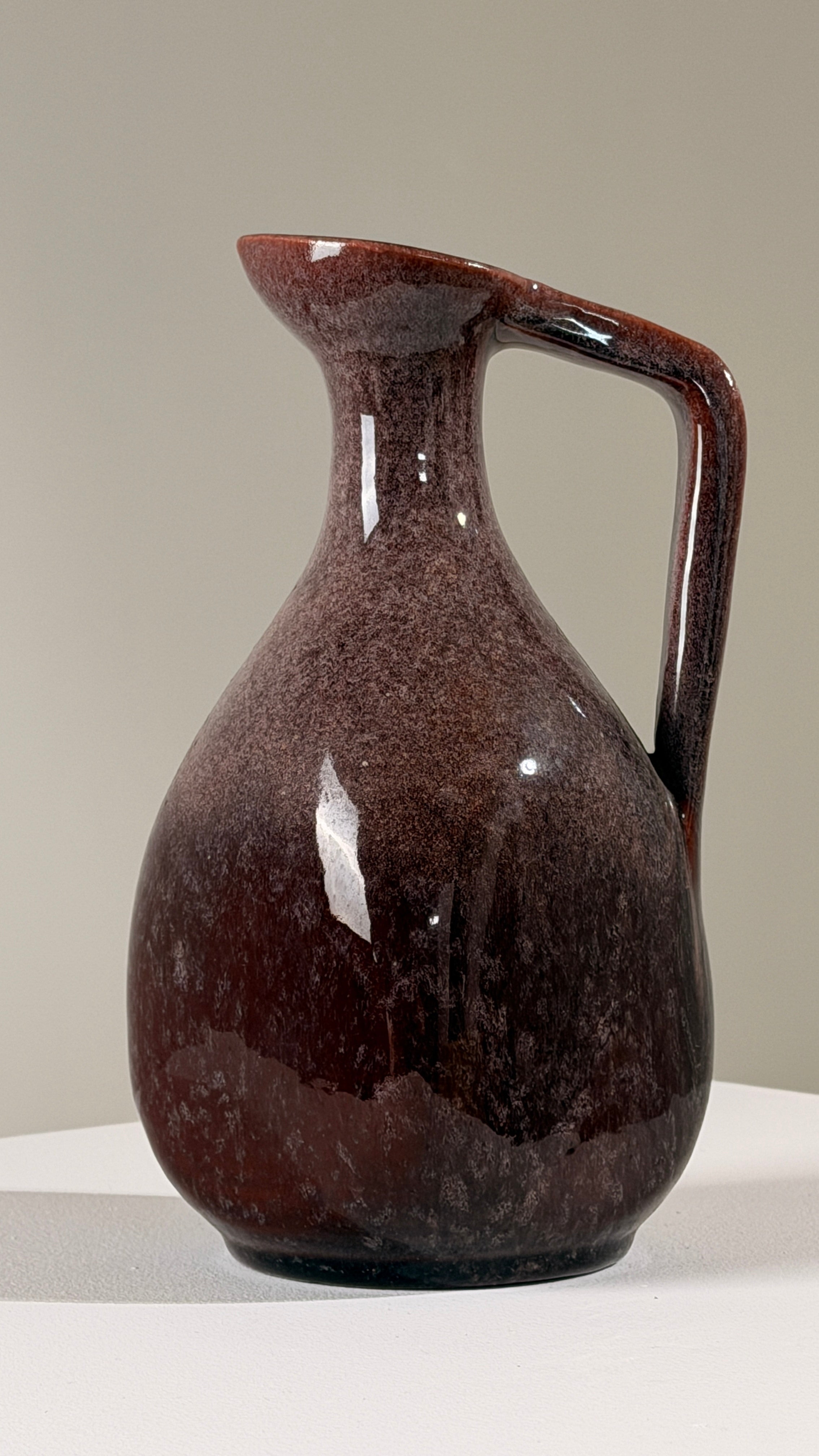 Ceramic pitcher by the Accolay potters, France, circa 1960 — side angle showing rich burgundy glaze