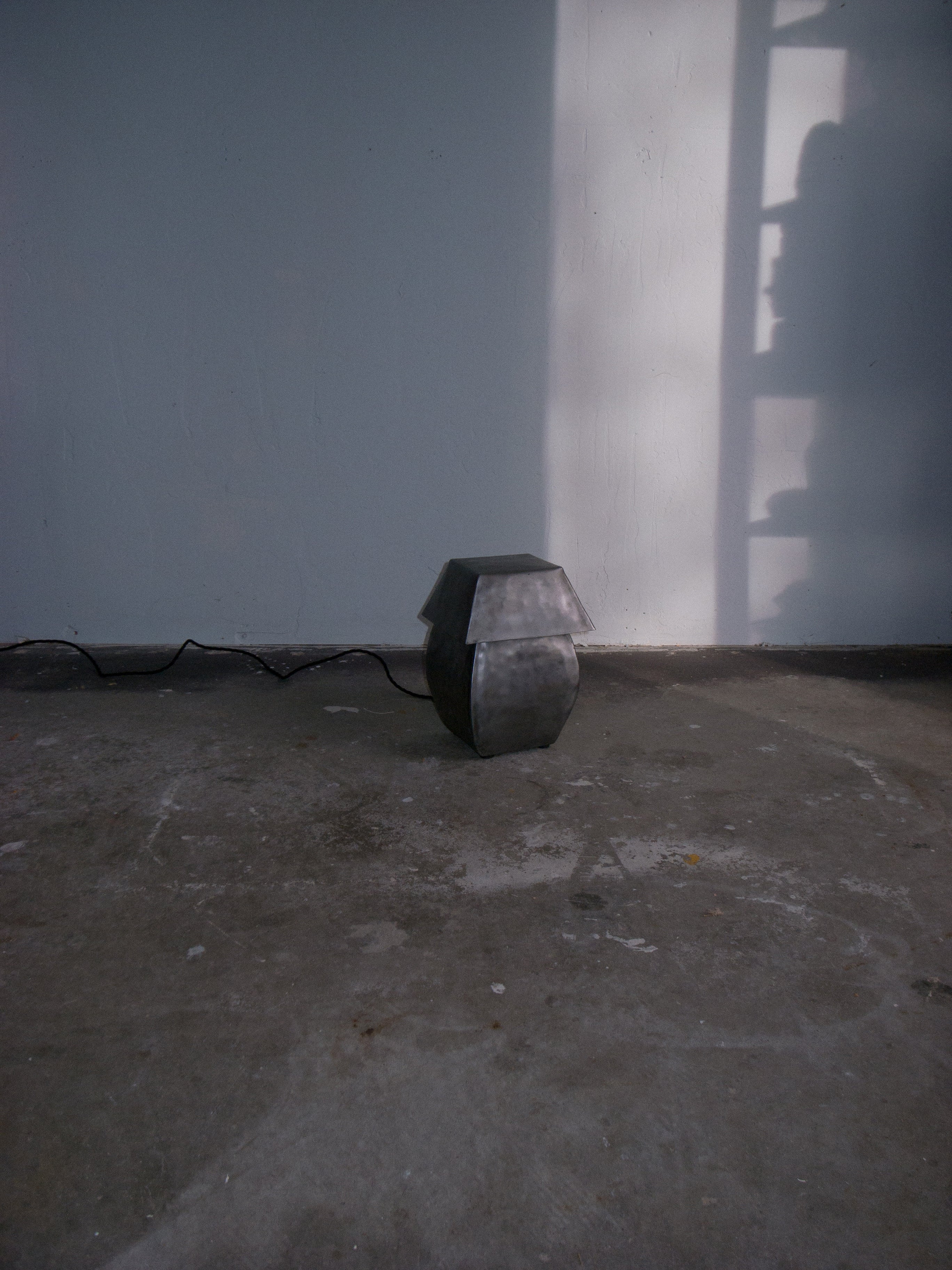 Short hammered steel table lamp by Jesse Butterfield in minimal setting