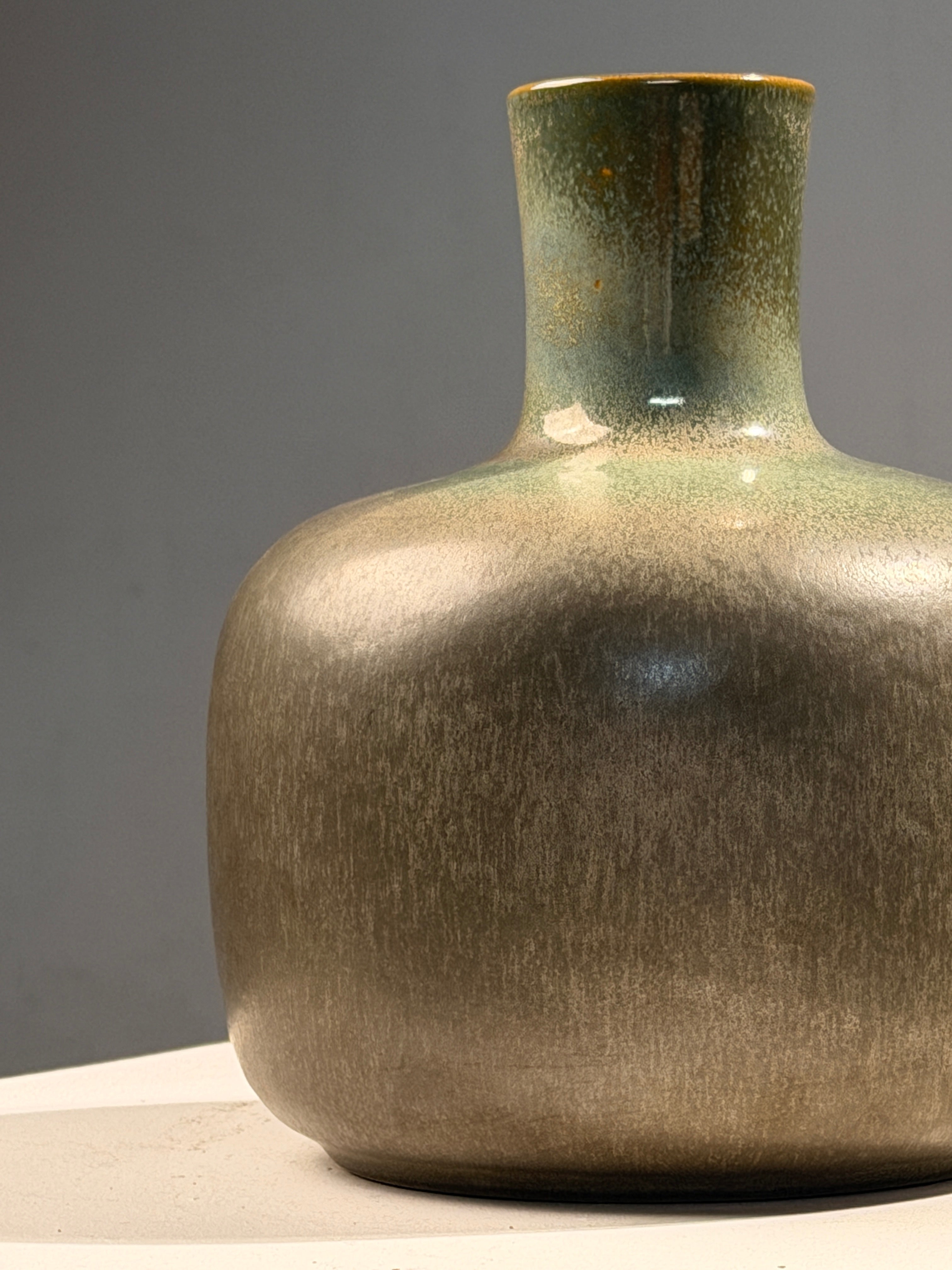 Speckled green glazed earthenware bottle vase, circa 1970 — side angle