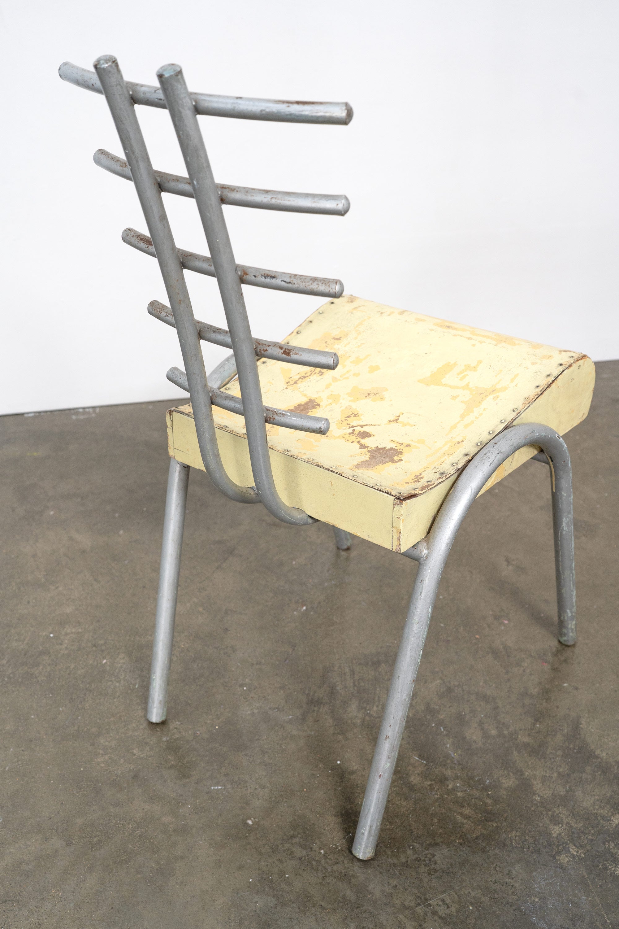 Postmodern prototype chair with yellow seat and gray metal frame