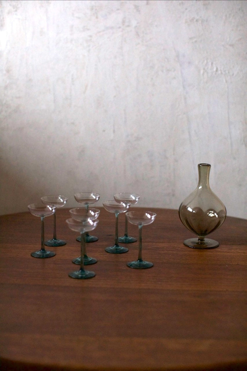 Glass Set — close-up of glass cups on wooden table