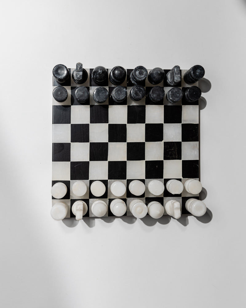Vintage marble chess set with black and white pieces on checkered board