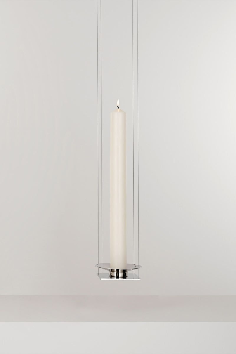 WAN PENDANT — close-up of white candle in chrome holder