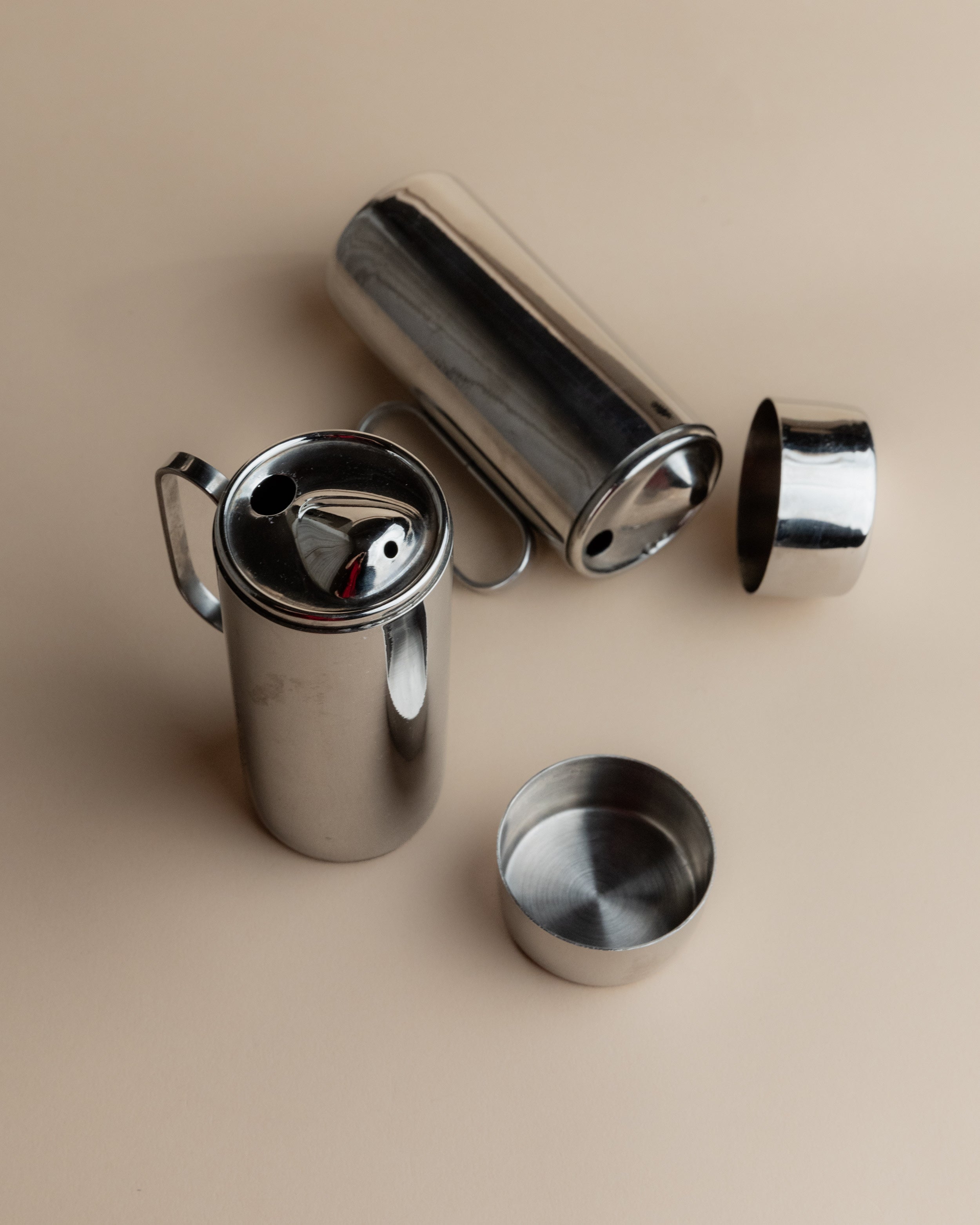 Disassembled view of 1980s stainless steel oil vinegar cruet set