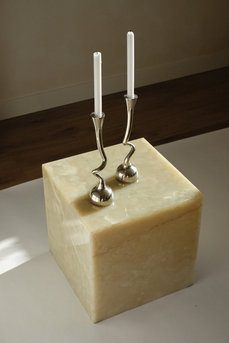 Pair of Curled Candleholders — close-up of polished silver on alabaster base