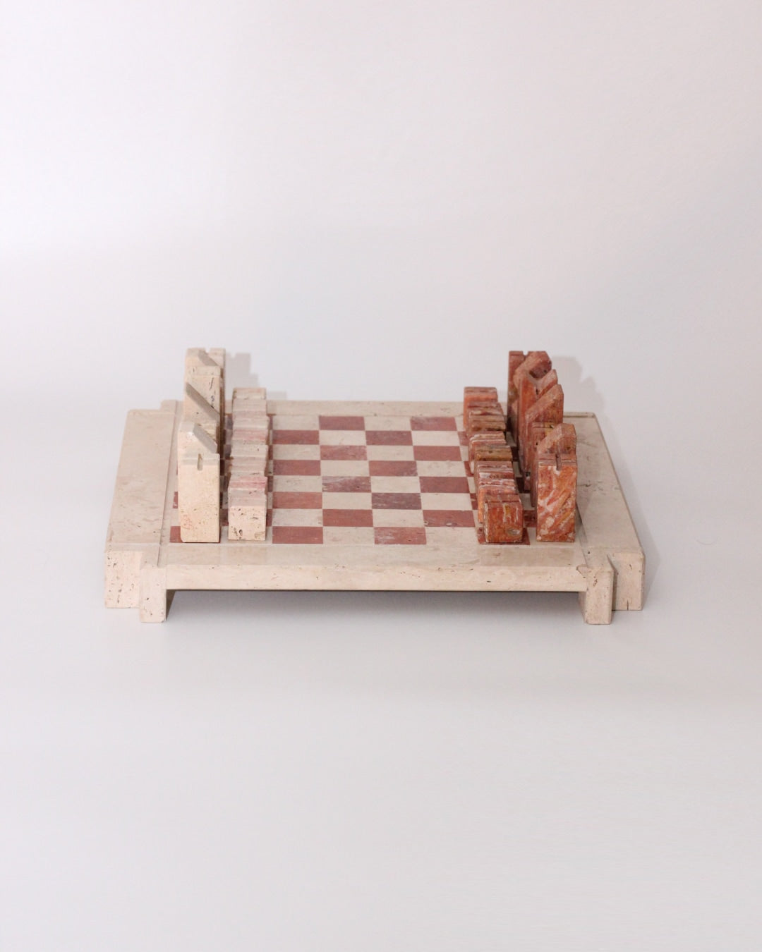 Modernist Chess Set — side angle of stone board with red and white pieces