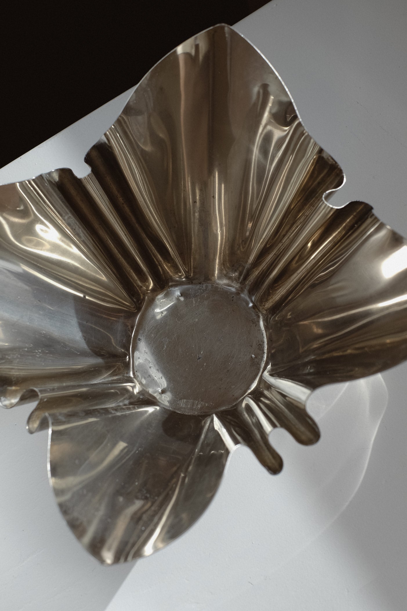 Folded Chrome Bowl — top view highlighting reflective metallic finish