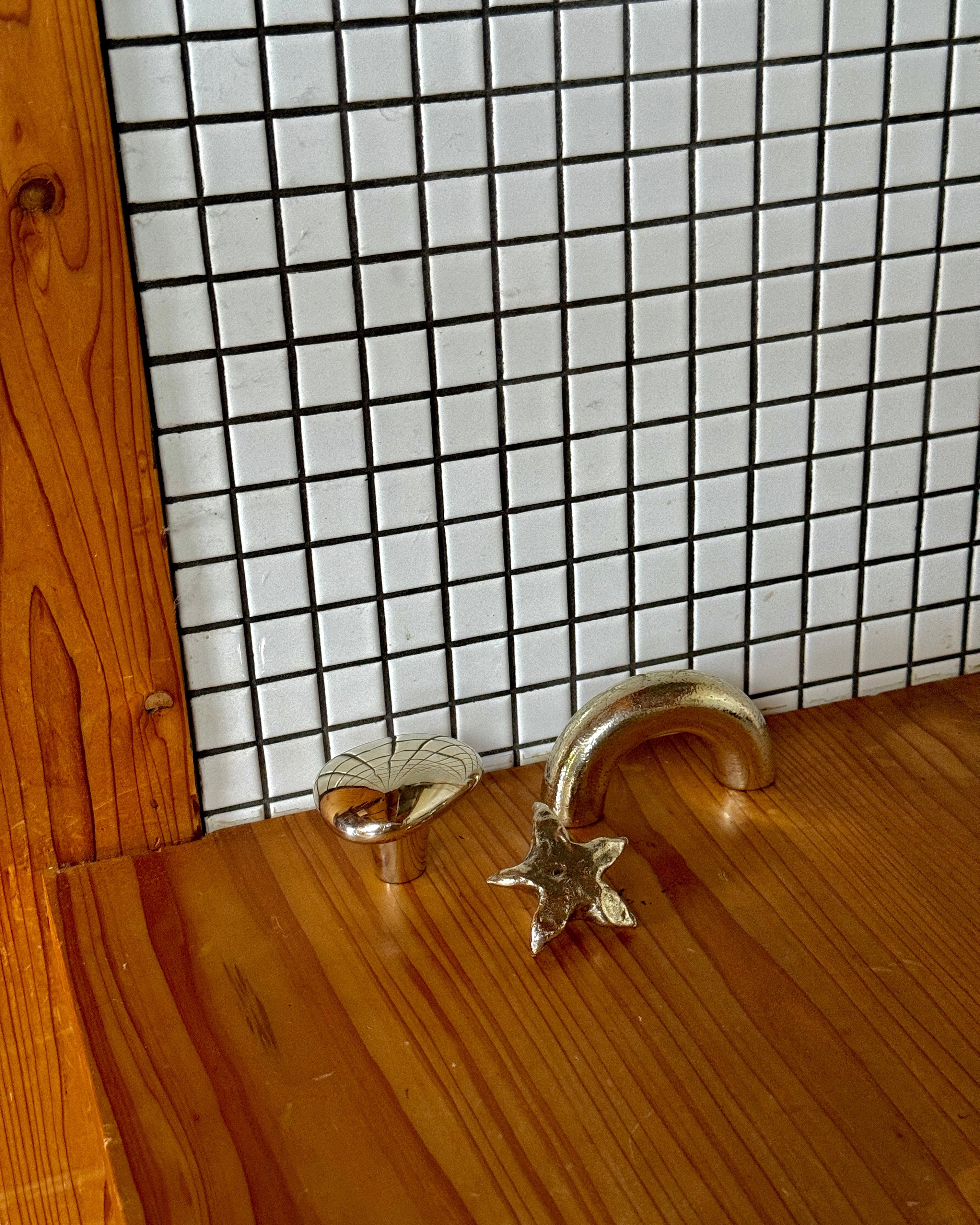 STAR Cabinet Knob/Wall Hook — detail of silver star shape on wooden surface
