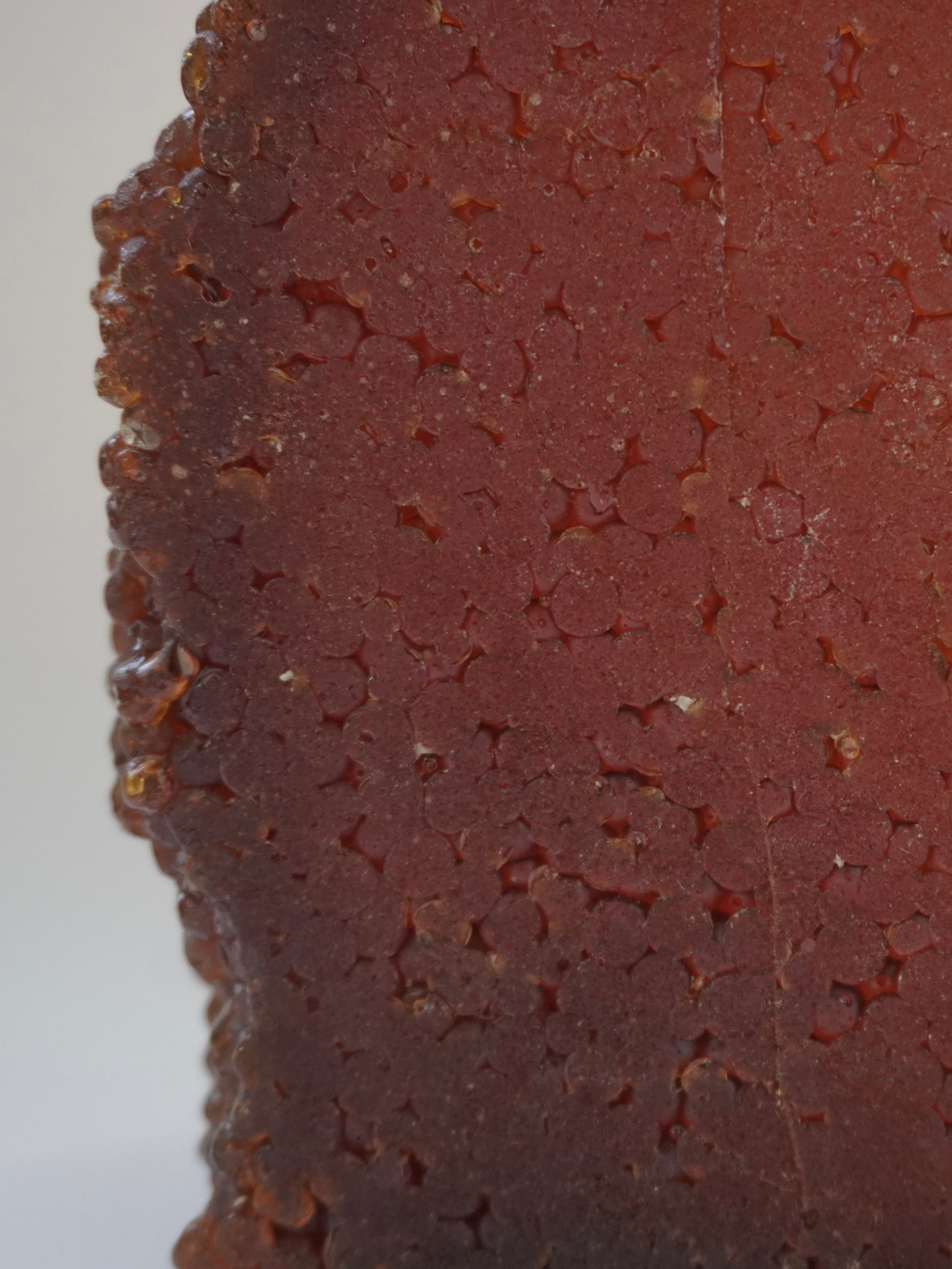 Pine Resin Vase — side angle showing textured red resin surface