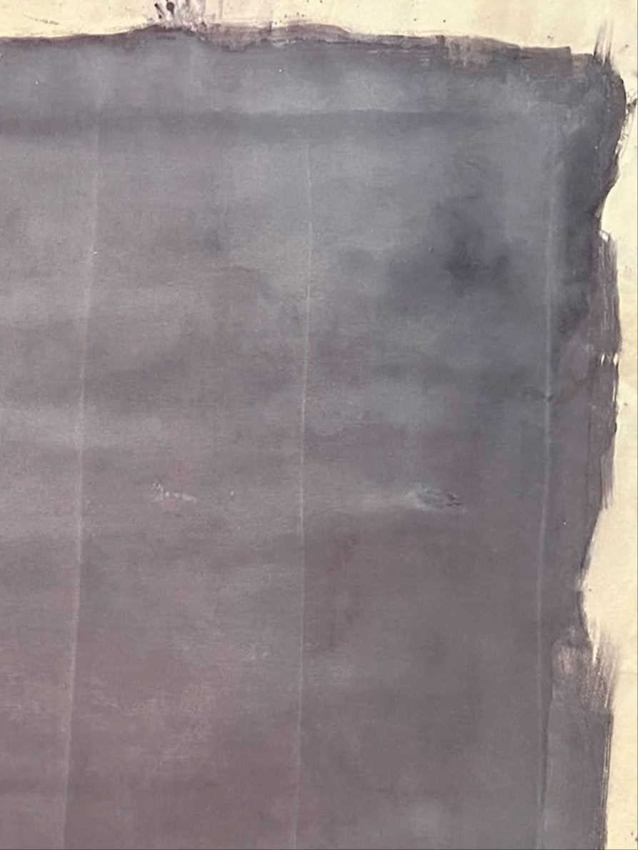 A large, rough-edged dark gray shape covers most of a light canvas in "Gray Mauve" Pigments, Ink on Raw Canvas by Médecine. Uneven edges and visible brushstrokes create a textured, abstract look.