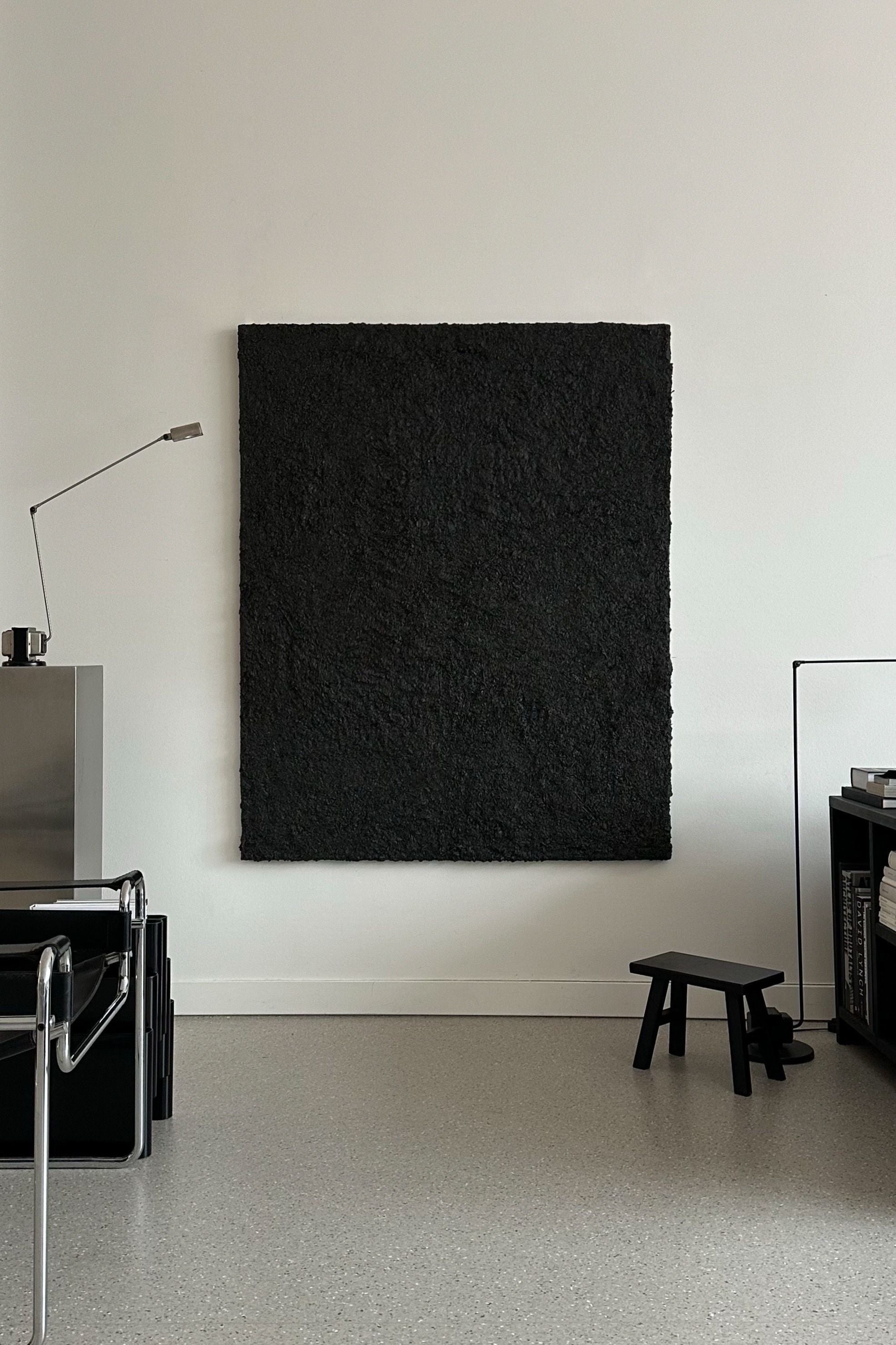 ARCHE 06' sculptural wall art — top view of textured black surface on white wall