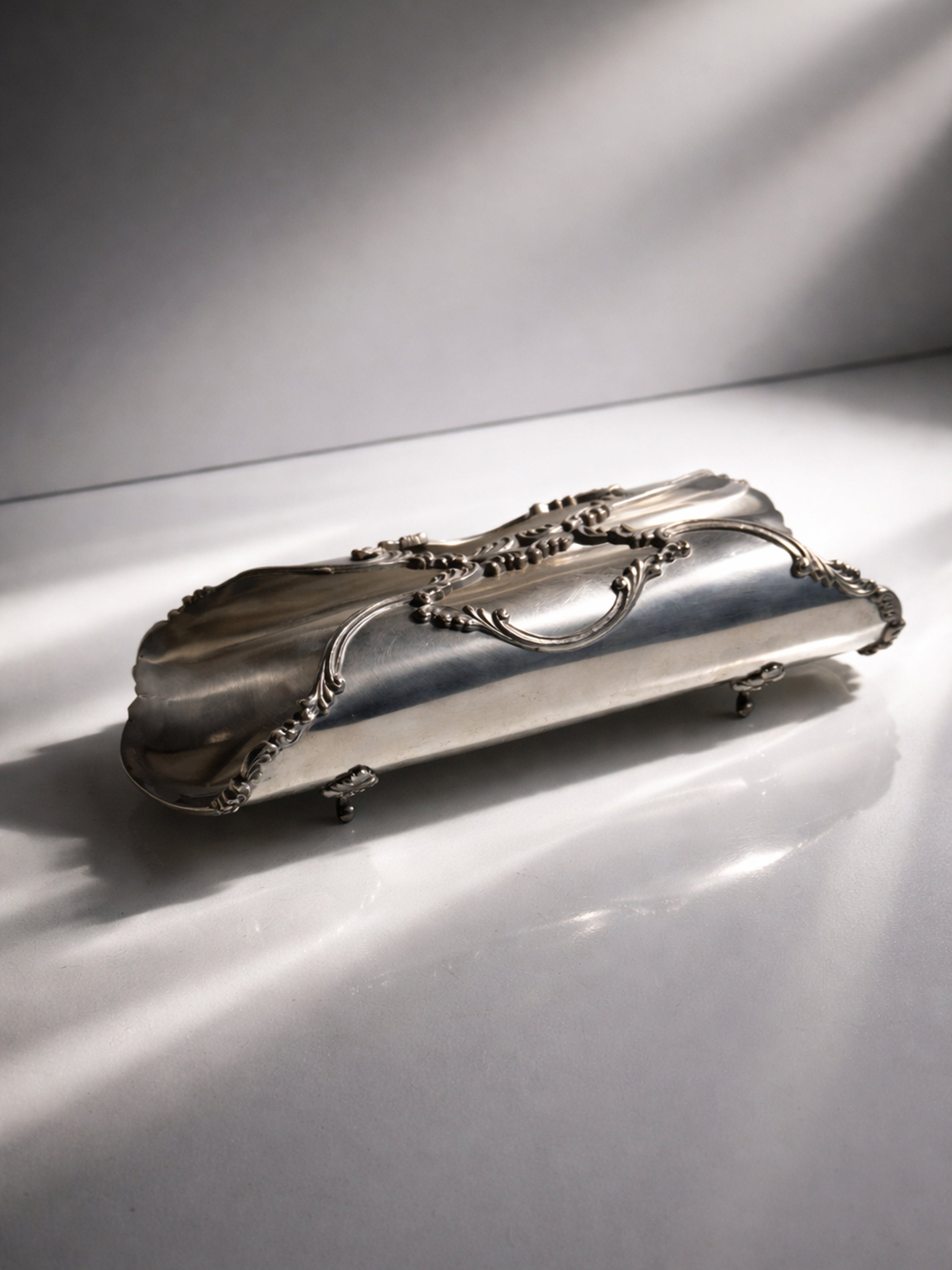 Italian Breadstick Holder - 1950s — close-up of silver surface with ornate details