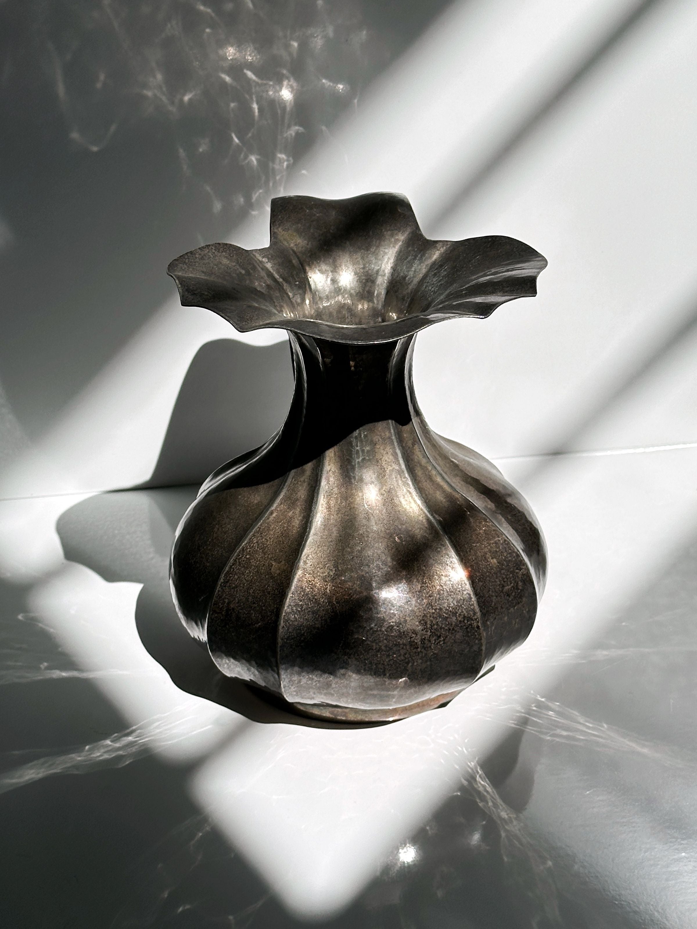 Silver-plated Art Nouveau vase with dramatic light and shadow detail