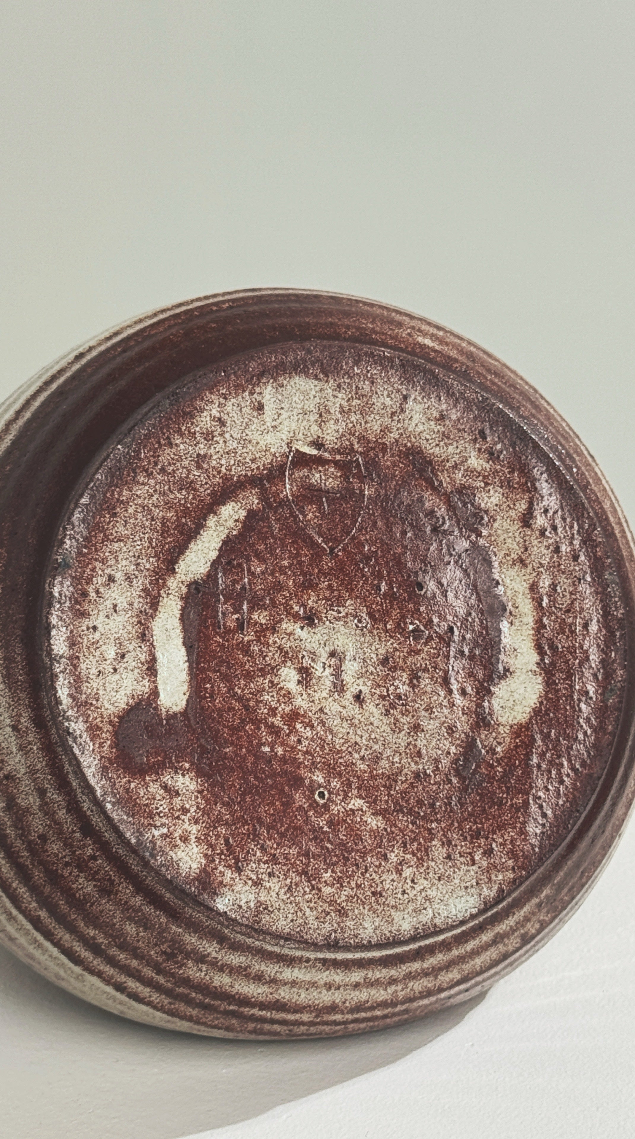 Bottom view of zoomorphic ceramic vase showing artist signature