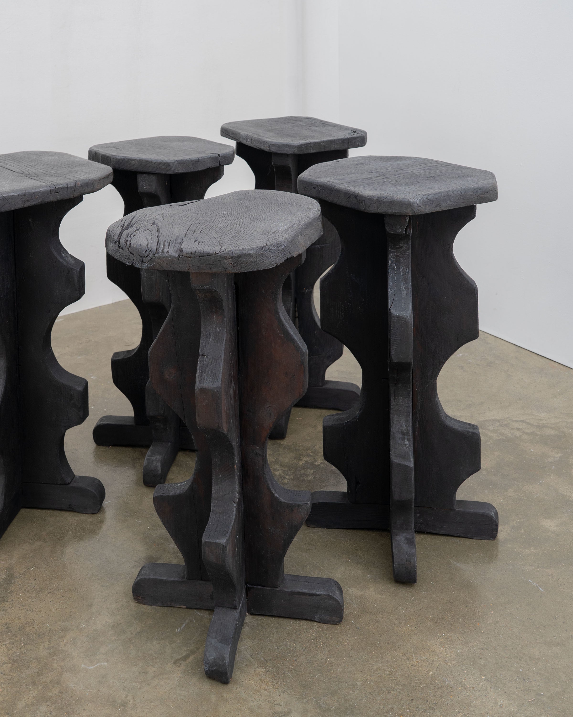 Sculptural Brutalist Bar Stools — top view of dark wooden seats