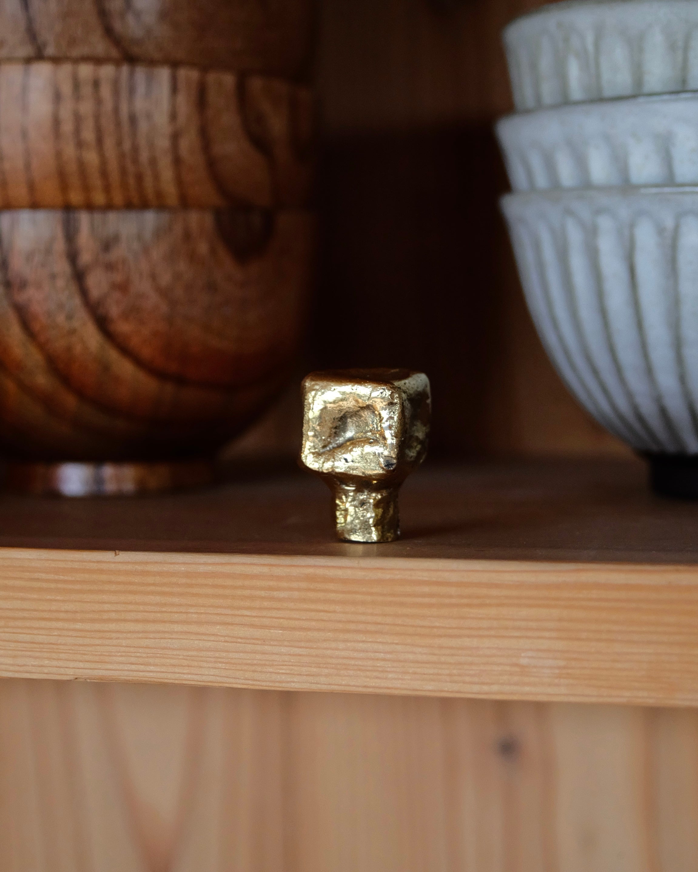 ISLE Cabinet Knob/Wall Hook Small — close-up of textured gold finish on wooden shelf