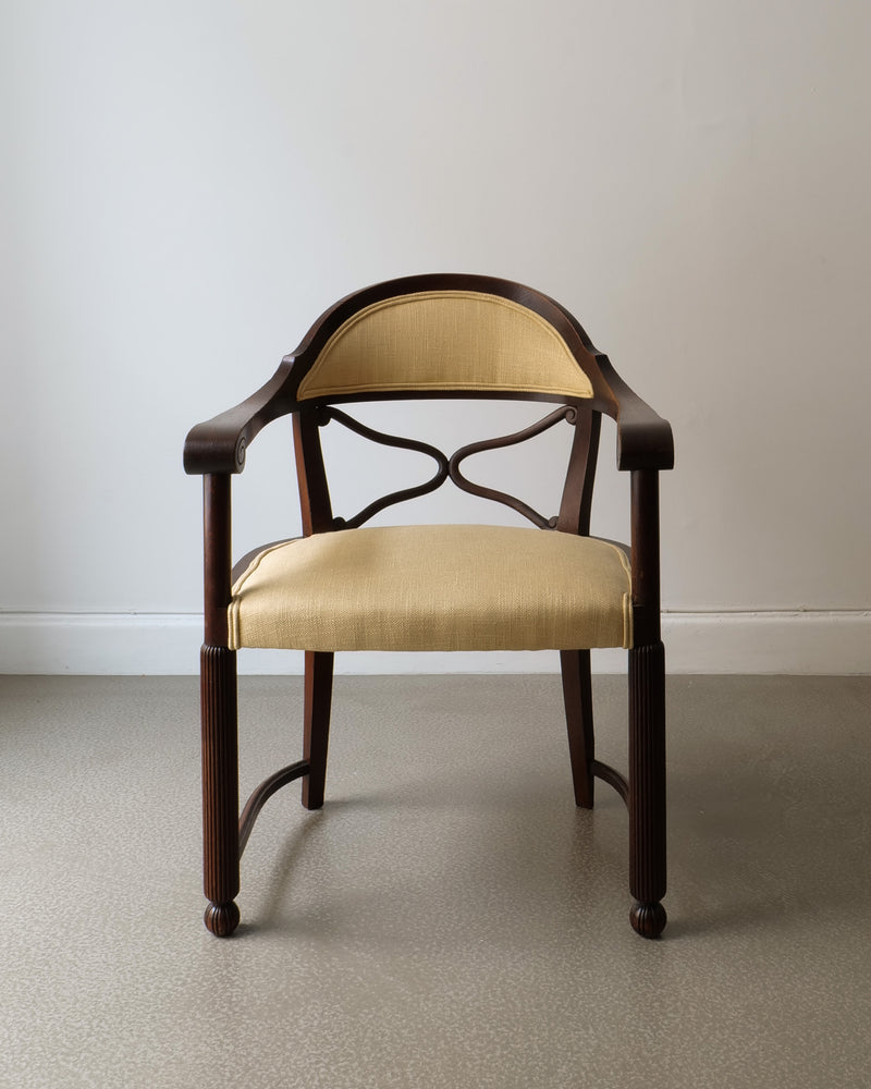 French Art Deco armchair with curved wood frame and beige upholstery