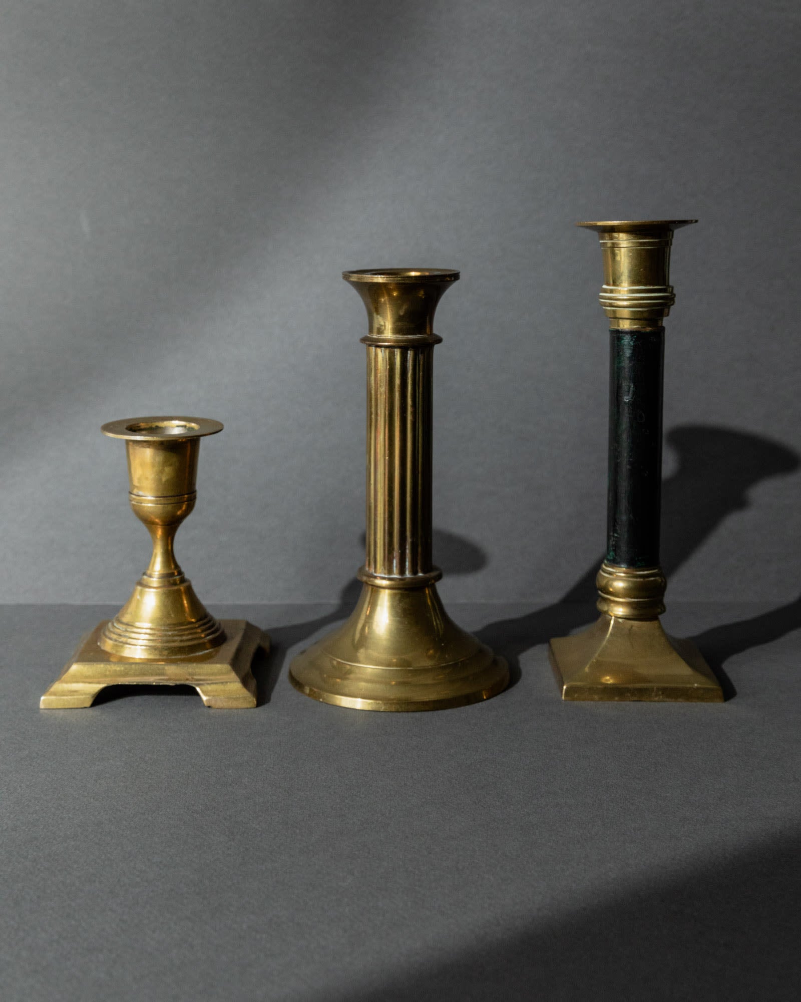 Vintage 1940s Brass Candleholders Set of 3, Mixed Shapes, Classic Antique Design — side angle showing three distinct brass de