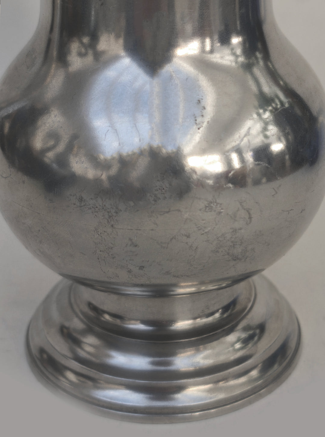 Small Pewter Pitcher — close-up of polished pewter surface