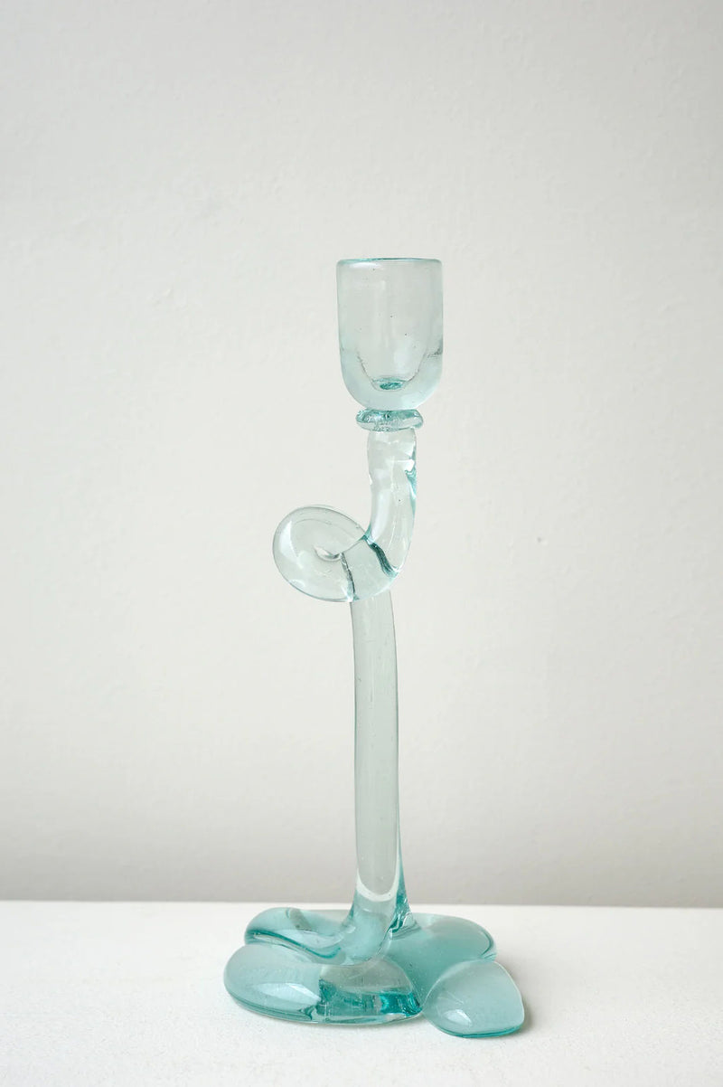 The Thaw - Recycled Glass Candleholder in Clear by Completedworks, featuring an abstract wavy design, sits on a white surface against a plain light background.