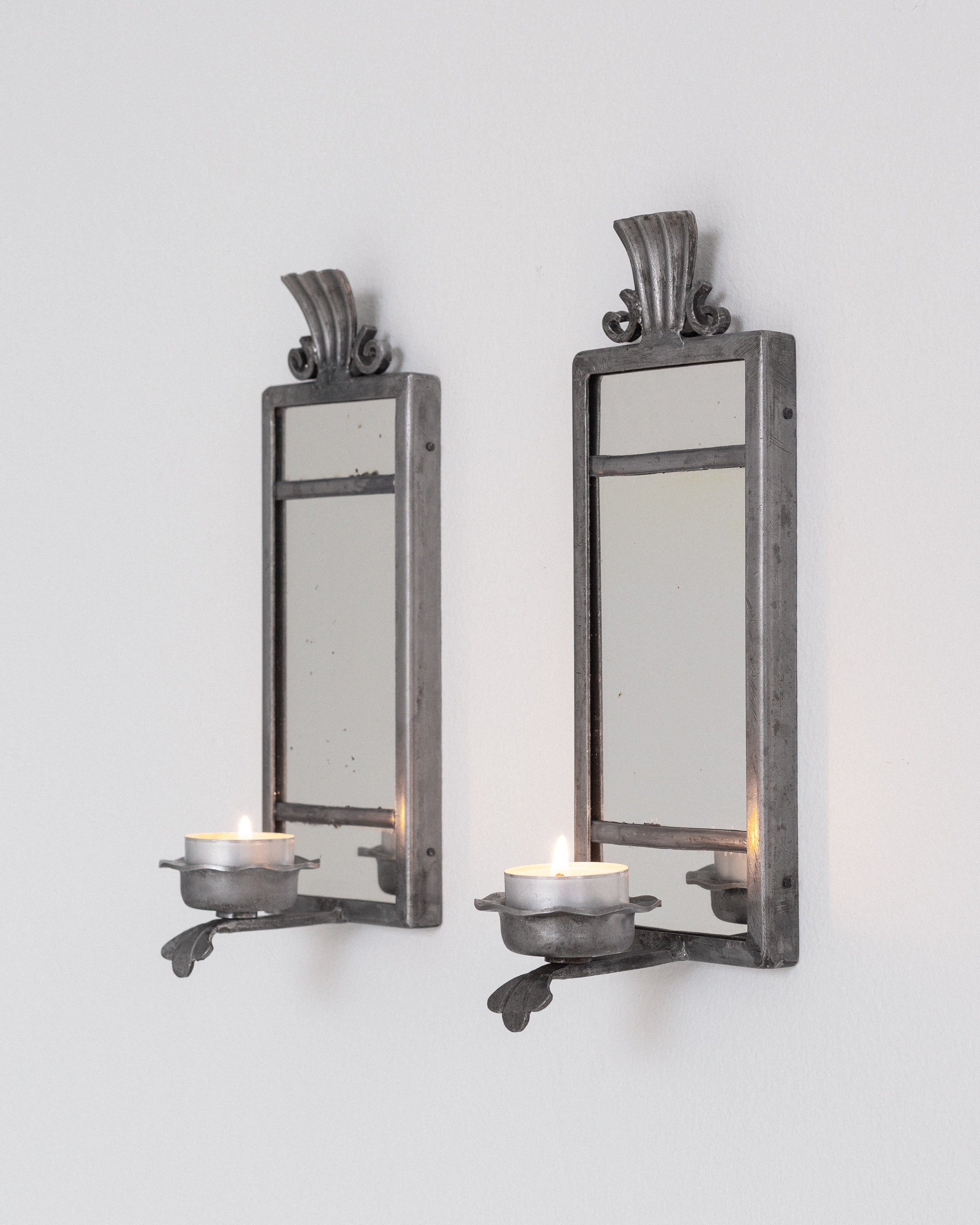 Pair of Art Deco Pewter Candle Sconces by Böhlmarks, Sweden, 1930s — mounted on white wall with lit candles