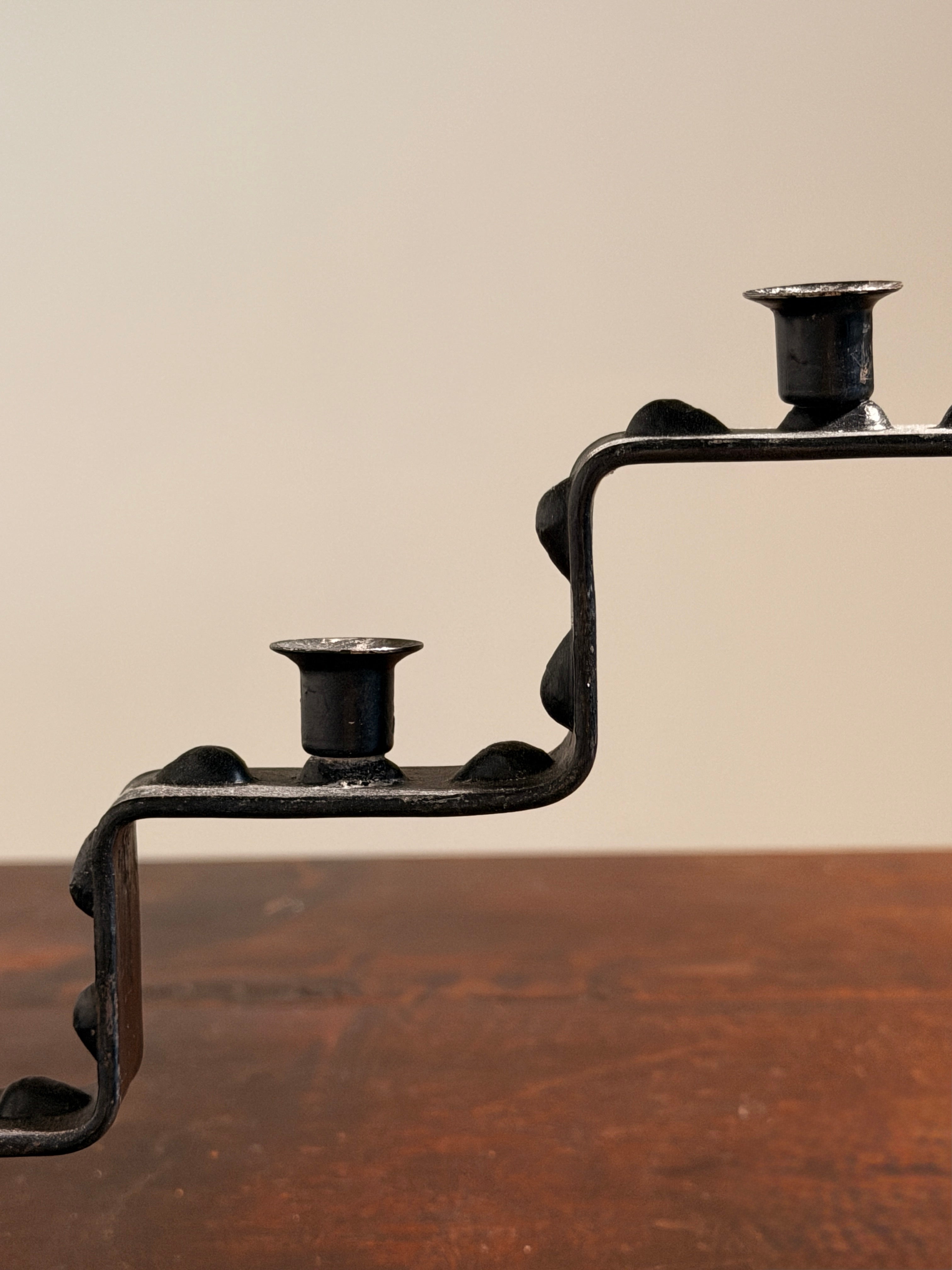 Seven-light geometric candelabra in black iron, circa 1960 — close-up
