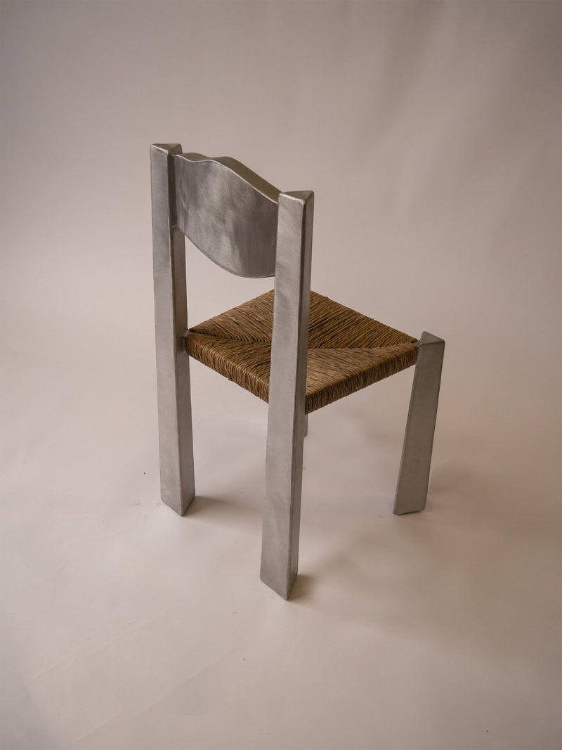 Woven Chair — angled view highlighting woven seat and metal frame