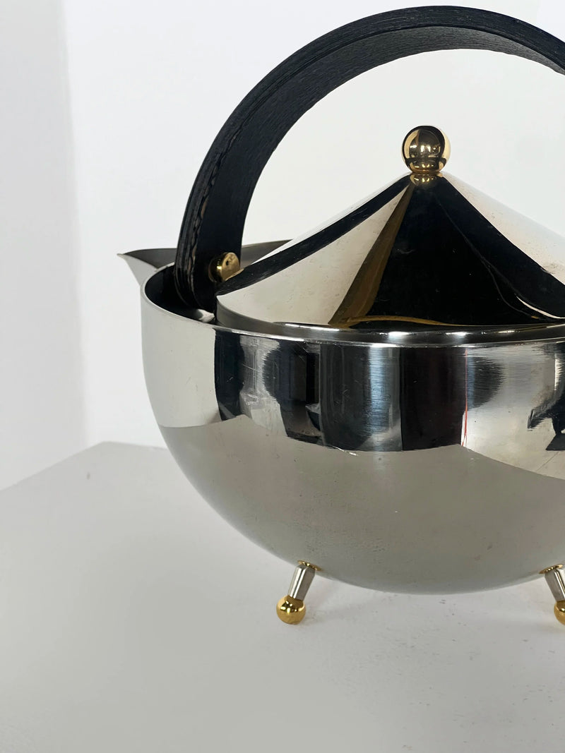 Carsten Jørgensen Teapot — close-up of polished metal with black handle