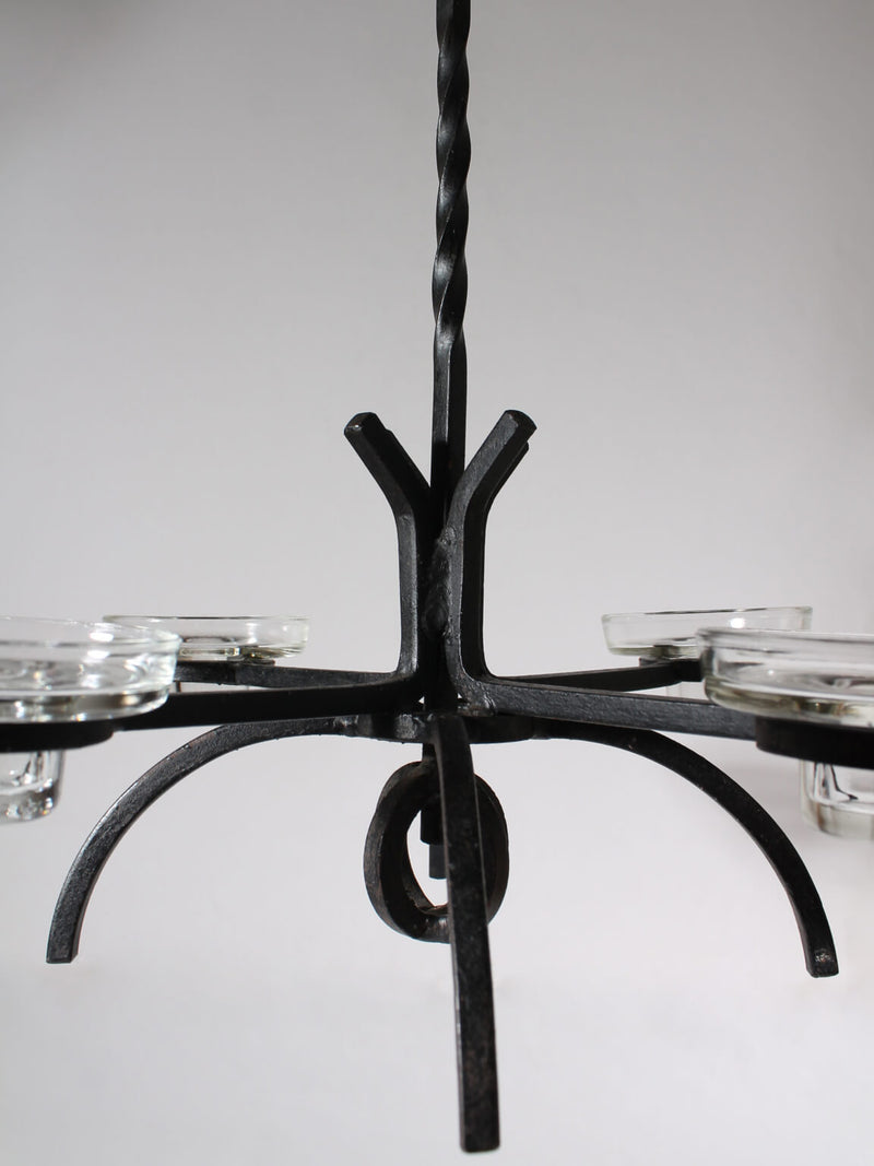 Cast Iron Brutalist Chandelier — close-up of black metal frame with candle holders