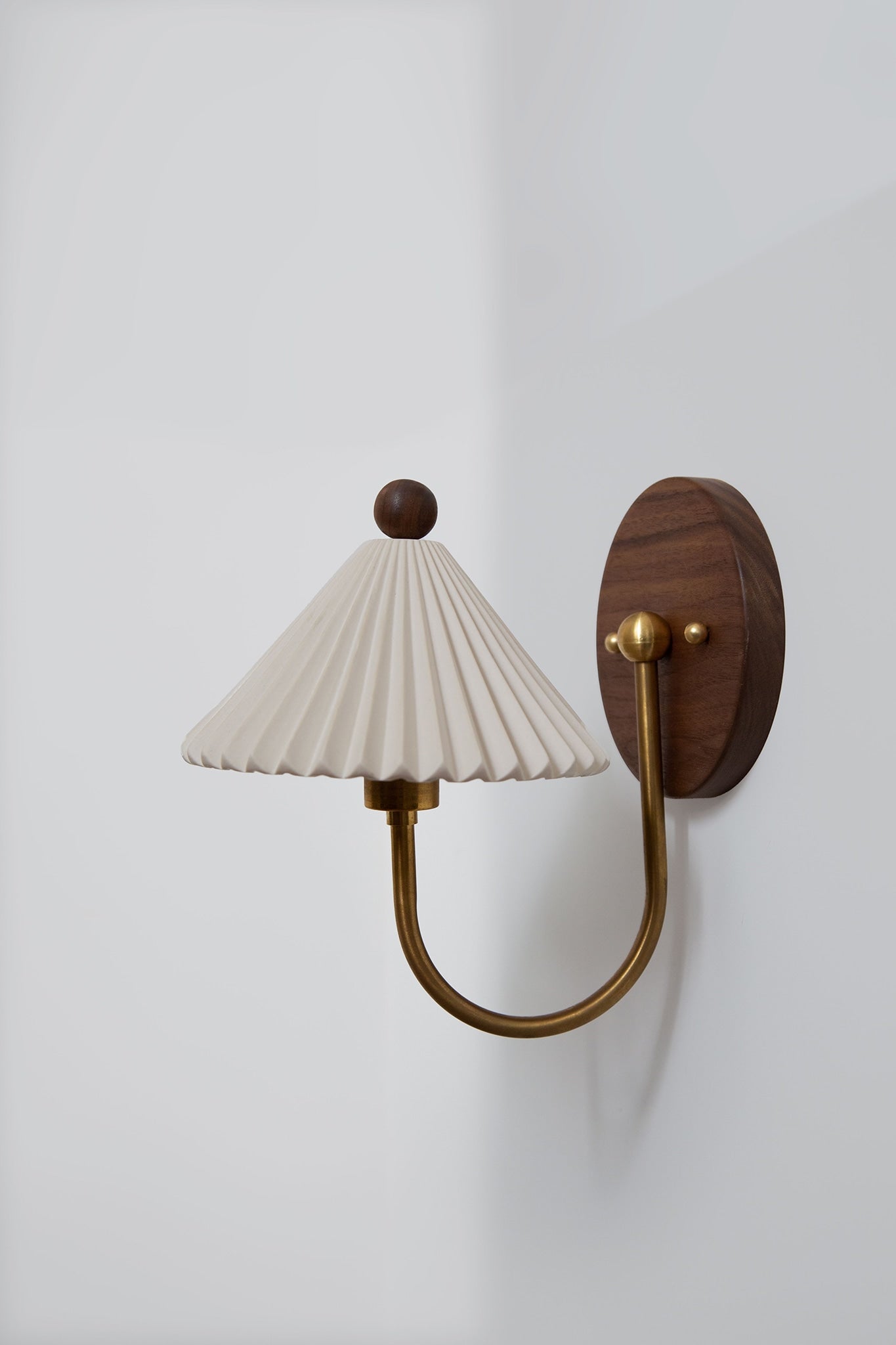 Prairie sconce wall light with pleated shade and walnut mount