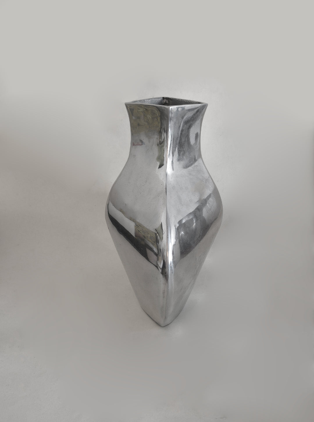 Sculptural Chrome Vase — side angle highlighting reflective chrome surface