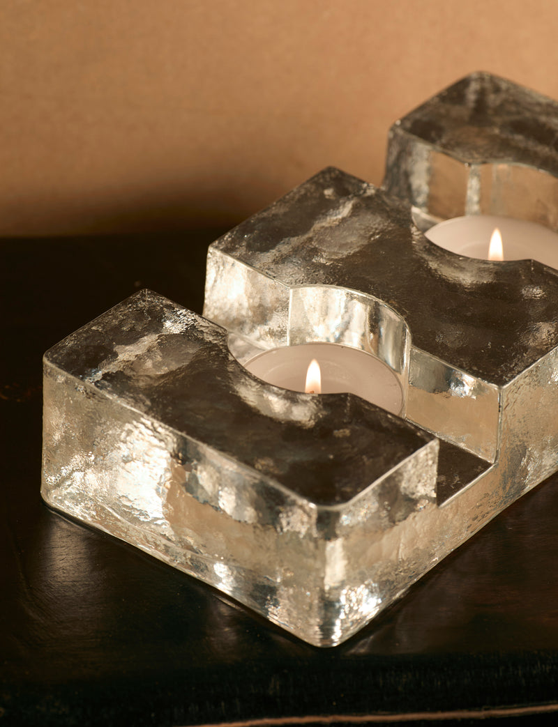 Important Scandinavian Clear Glass Candle Holder c. 1960 — close-up of clear glass with lit candles
