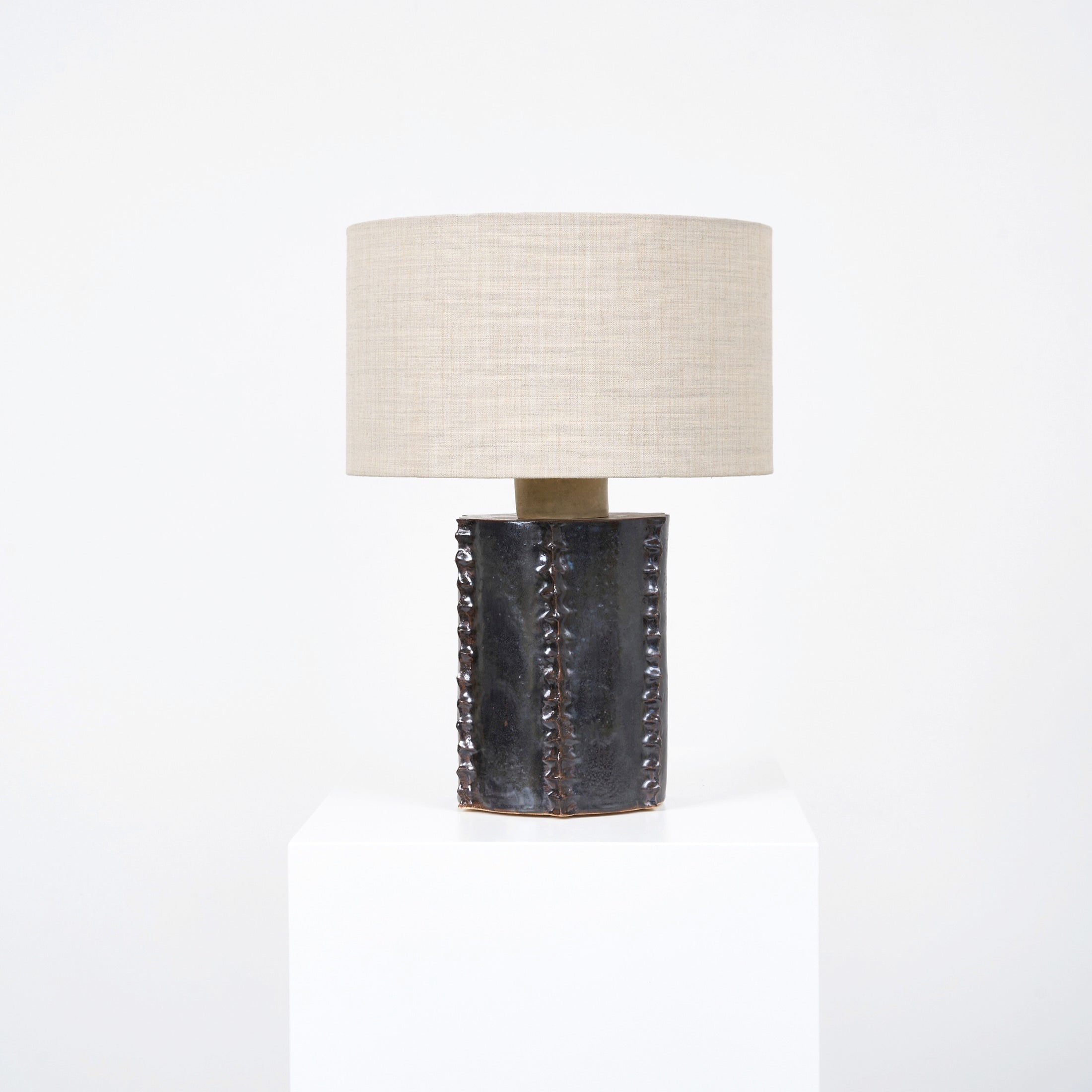 Totem Table Light — close-up of textured black ceramic base