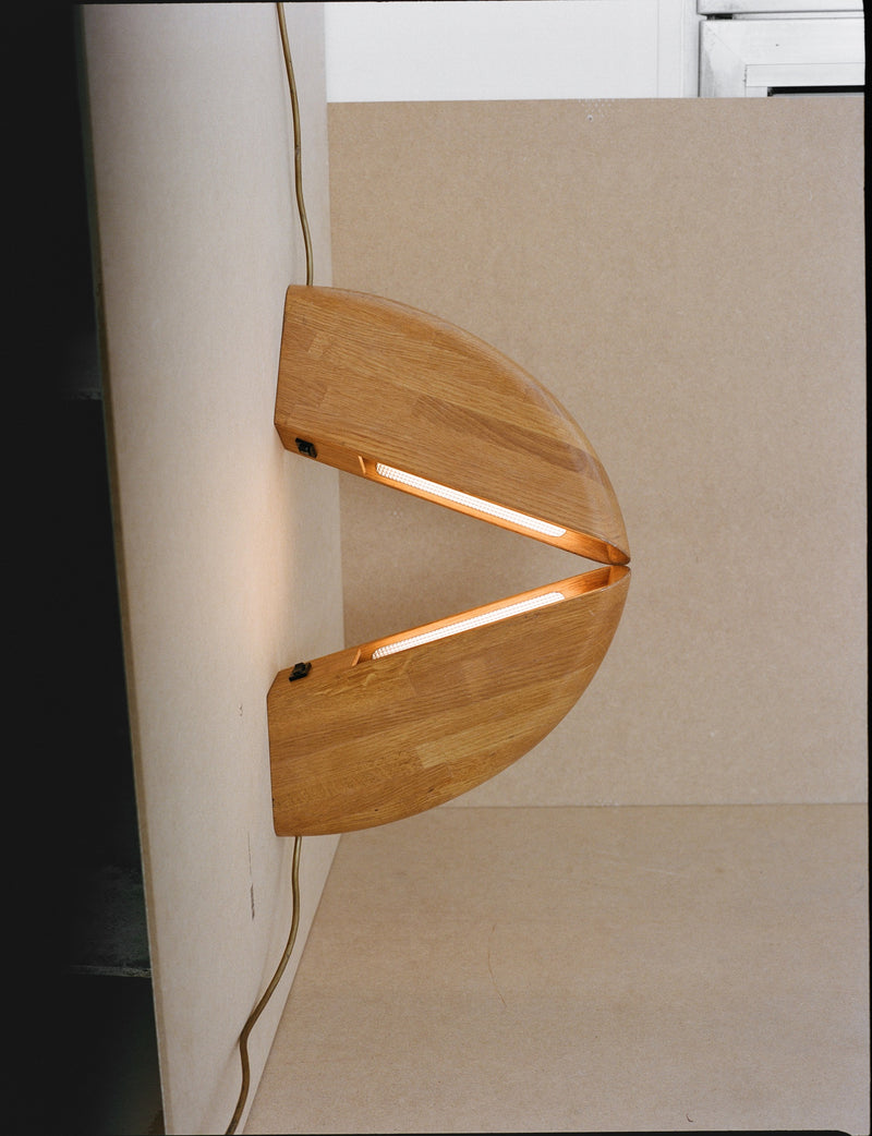 Set of 2 Vintage French Artisanal Table Lamps in Solid Oak Wood C. 1980 — close-up of wooden lamp body with light on