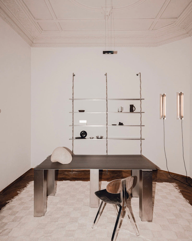 Modern wall-mounted shelving system with ceramic objects in minimalist dining room