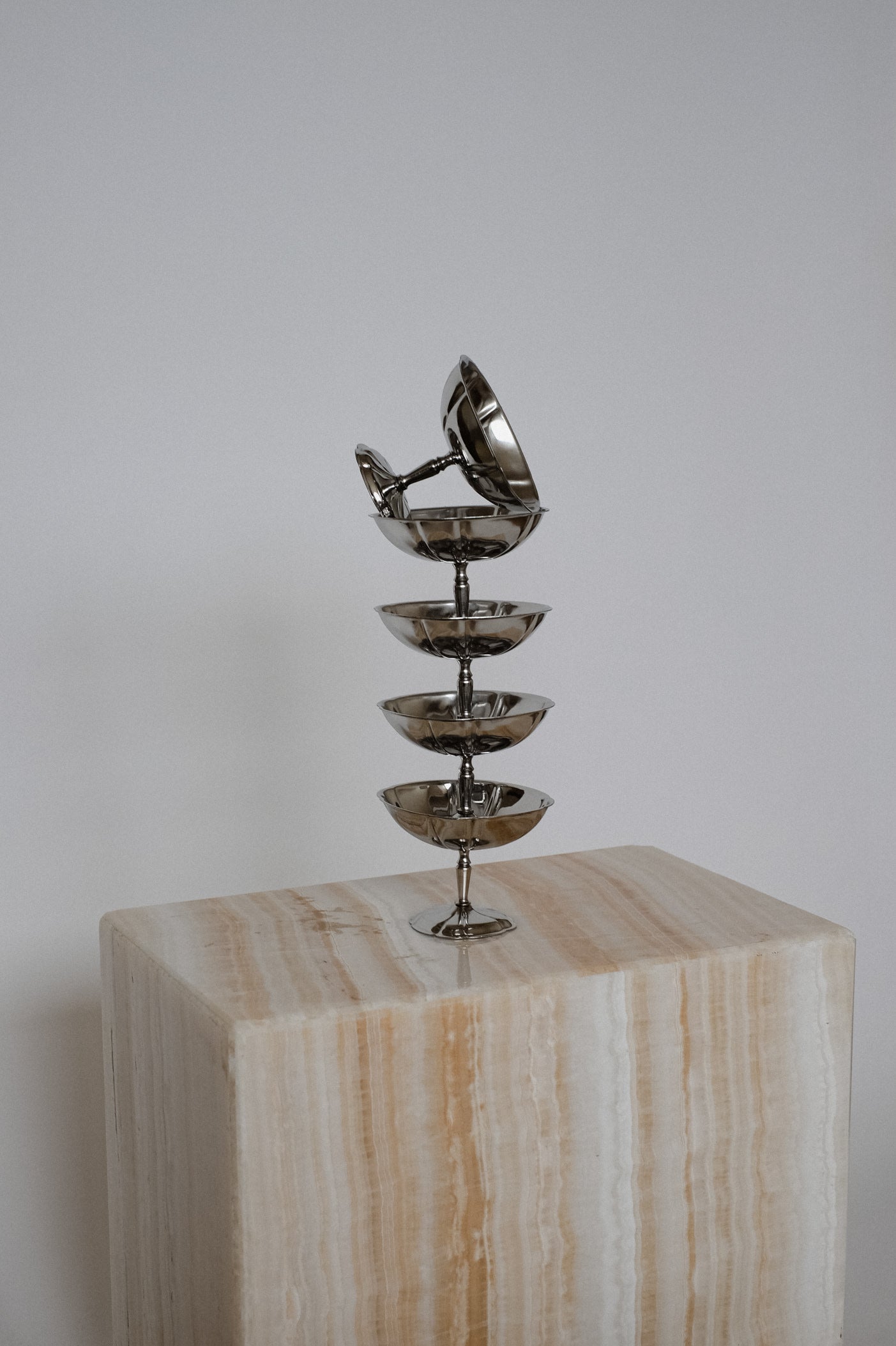 Set Large Ice Coupes — stacked metal bowls on stone pedestal