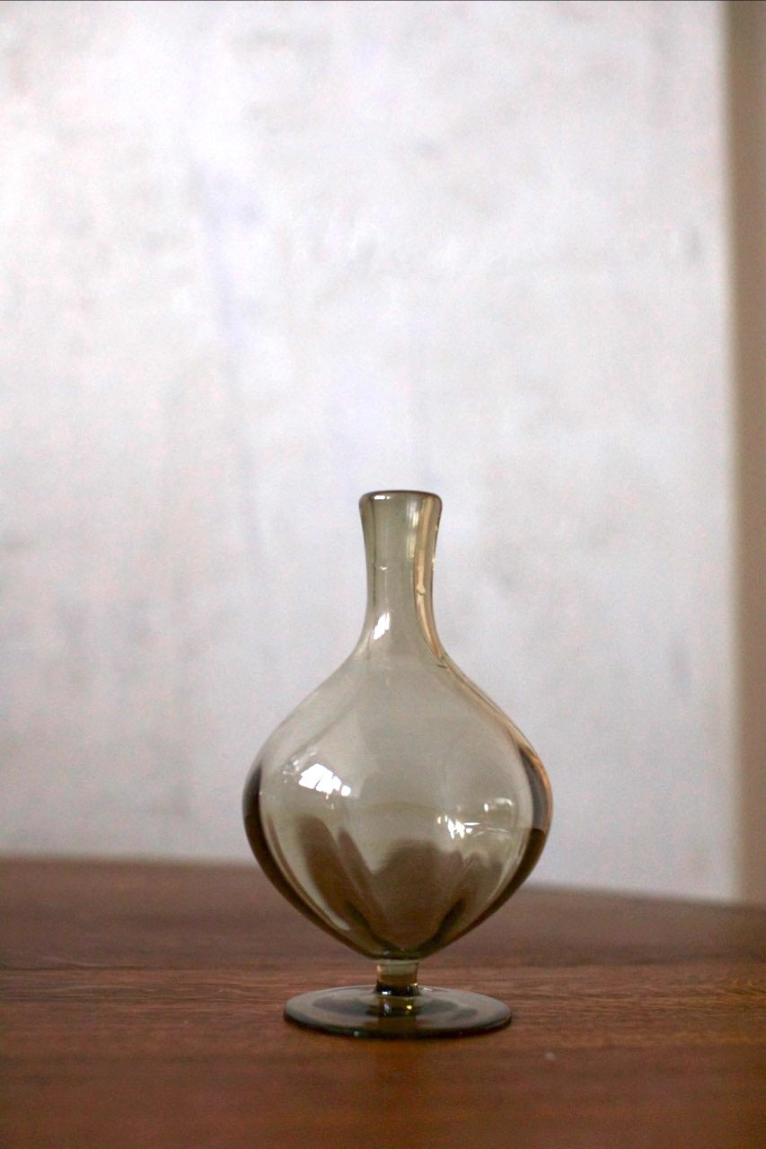 Glass Set — side angle of smoky glass vase on wooden table