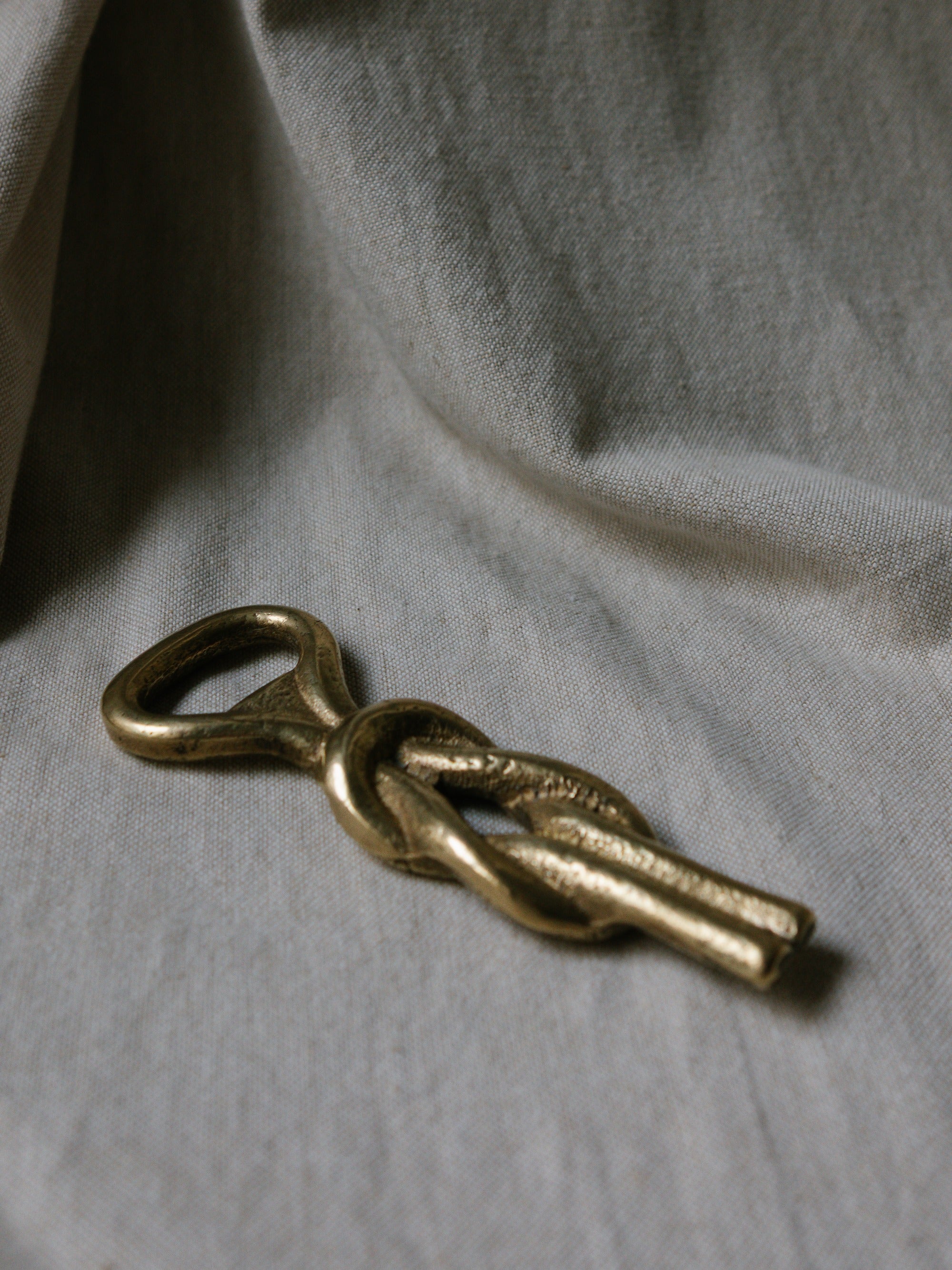 Sailor’s Knot Bottle Opener, Italy, c. 1960s — top view on textured fabric