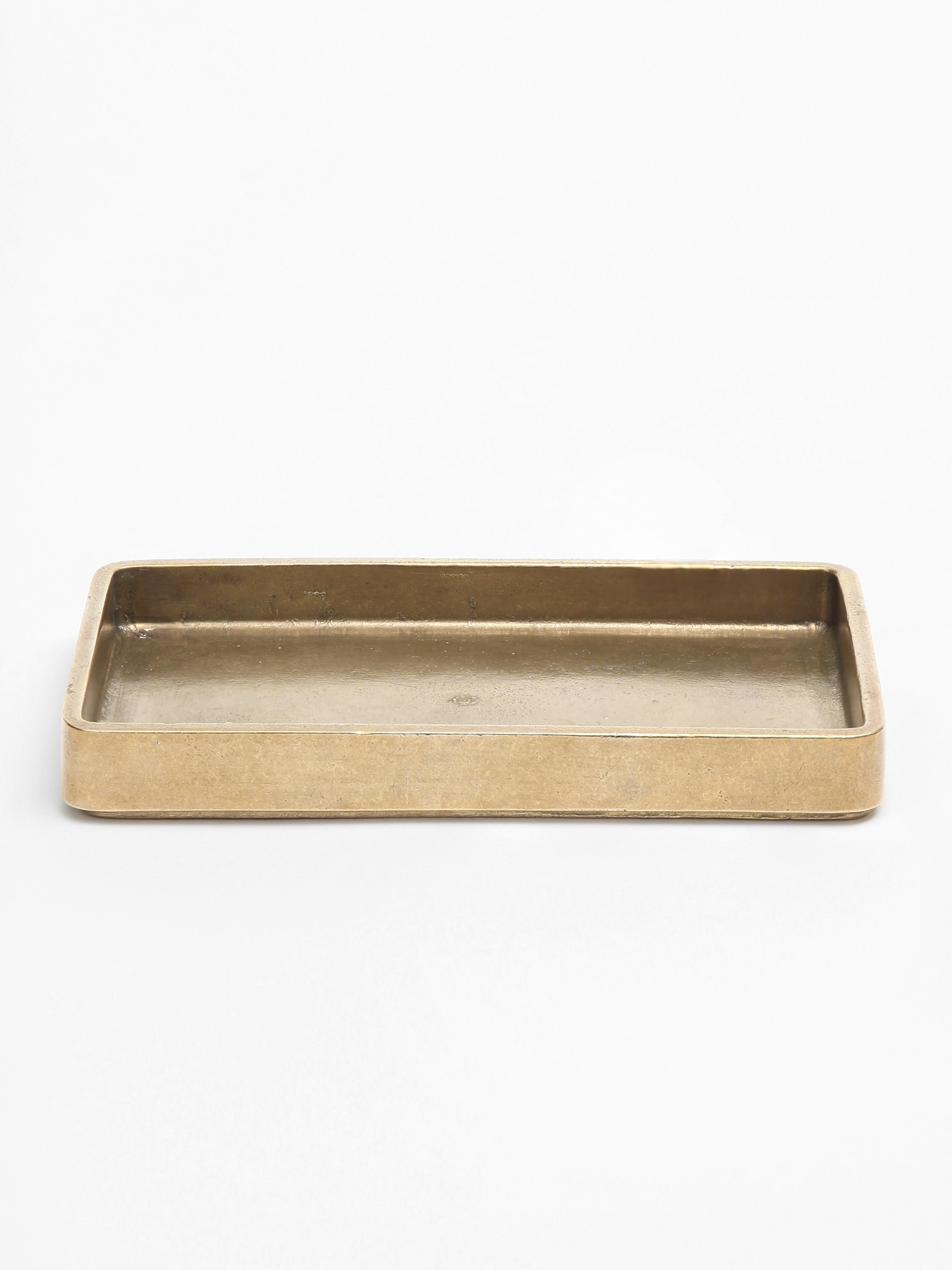 Plato Table Tray — close-up of brass surface with raised edges