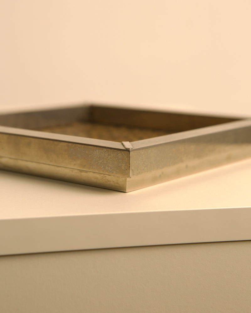 Golden square metal vide-poche detail showing refined edges, 1970s
