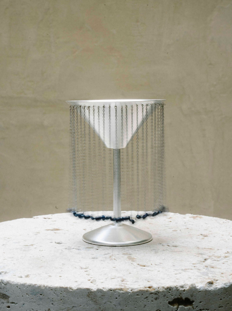 CELEBRATION GLASS X TALLER MARMO — close-up of silver cocktail glass with chain detail