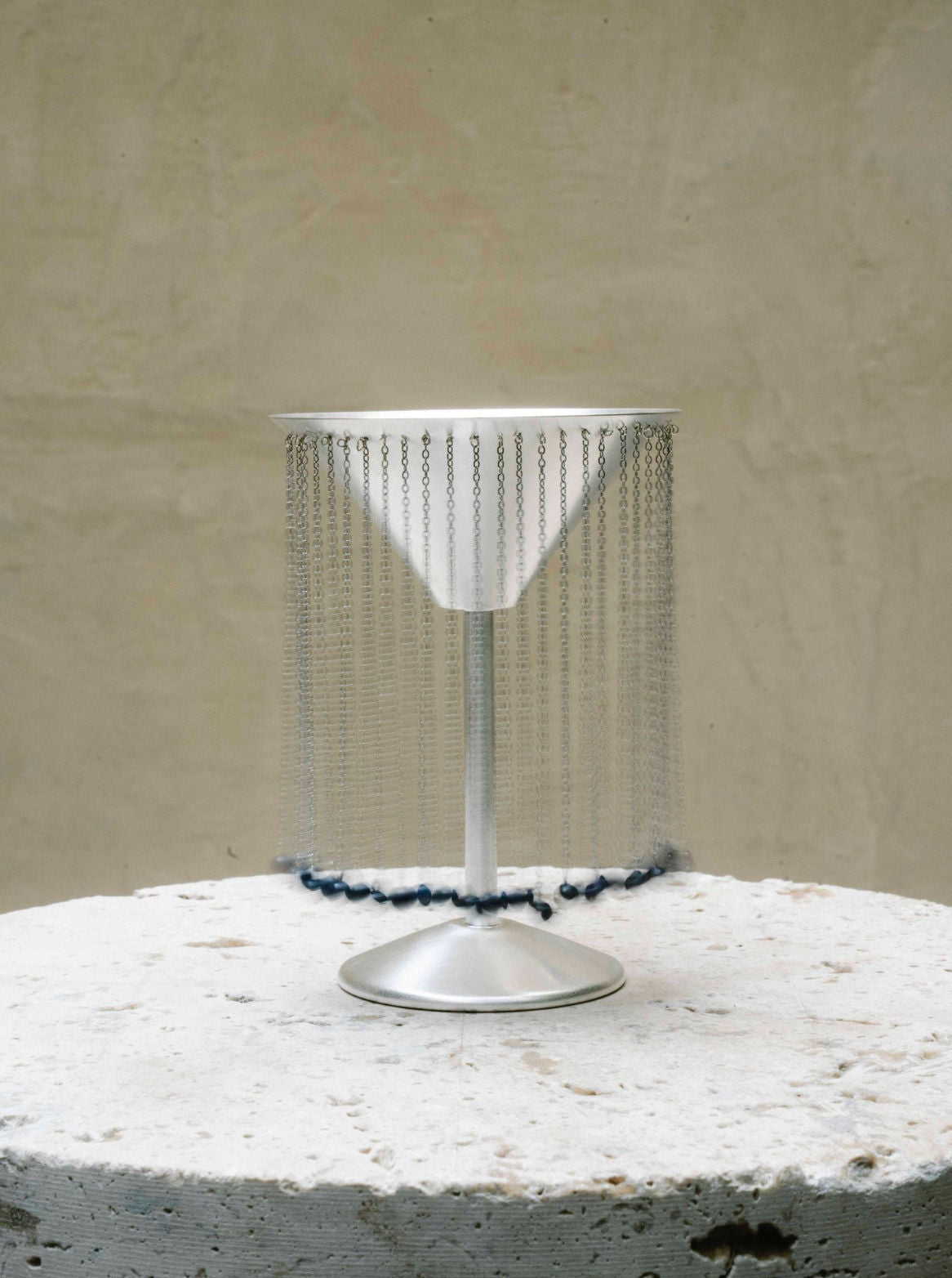 CELEBRATION GLASS X TALLER MARMO — close-up of silver cocktail glass with chain detail