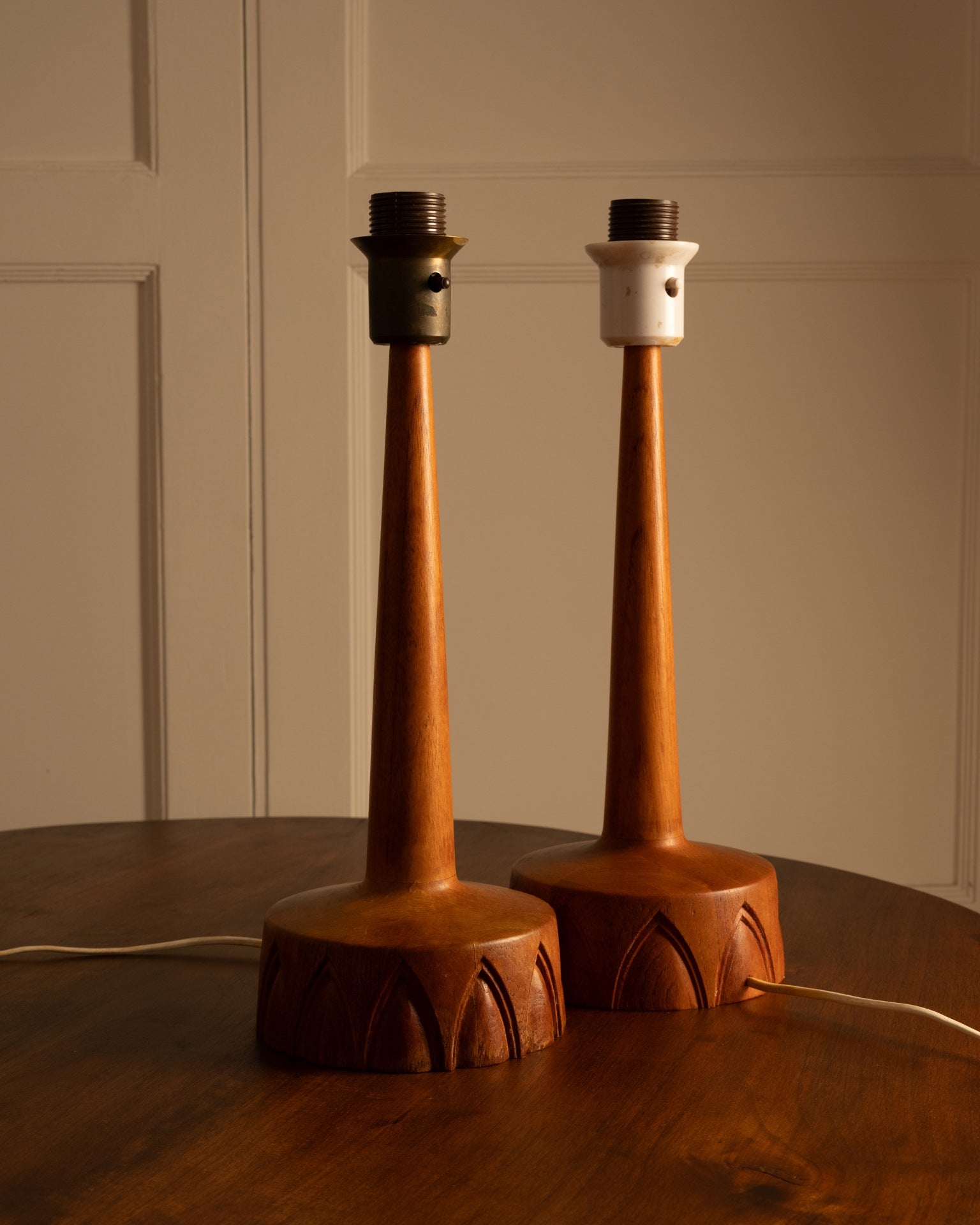 Pair of Swedish teak table lamps with carved arched base detail