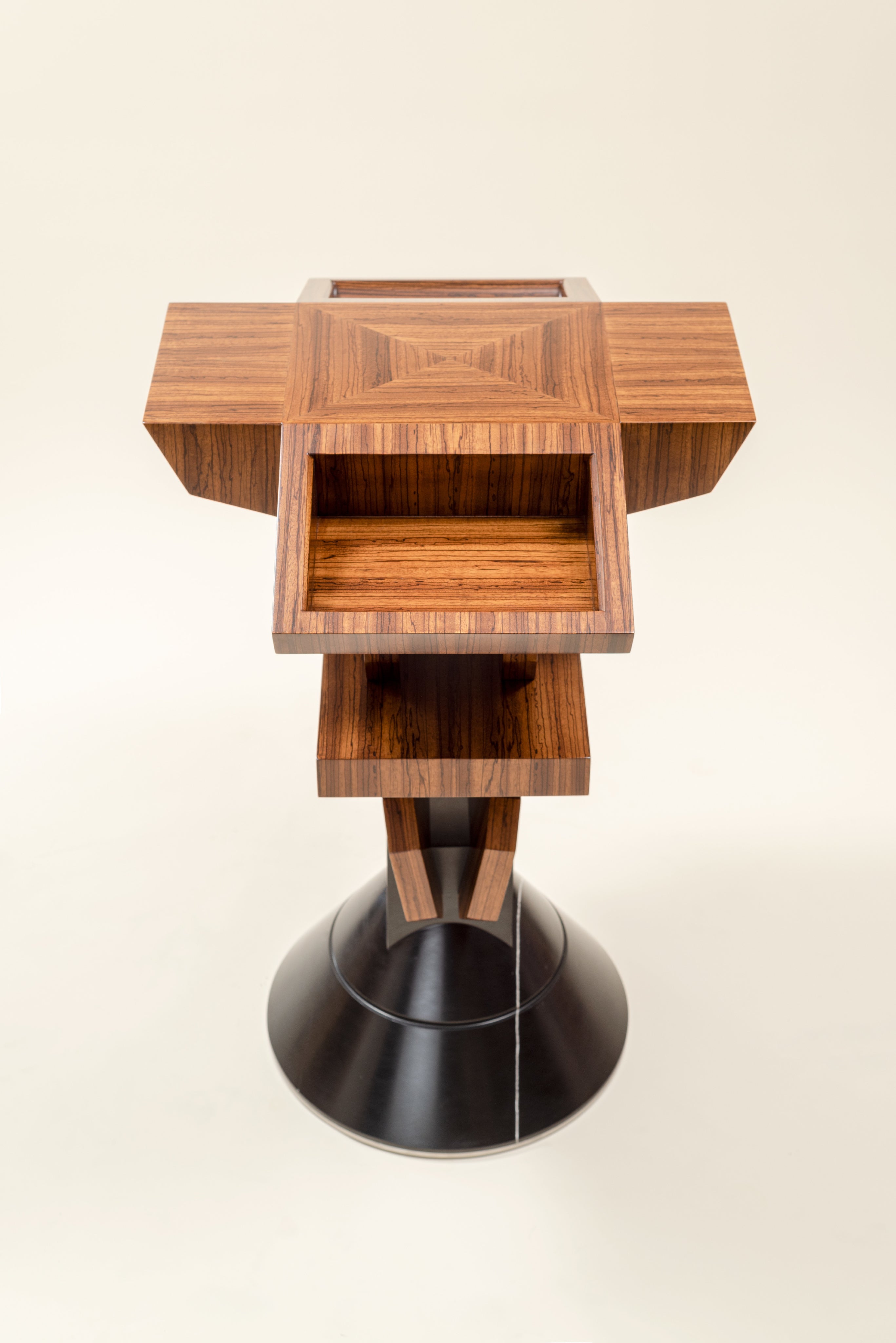 Pyramiss Pedestal Table — top view of wooden surface with drawers