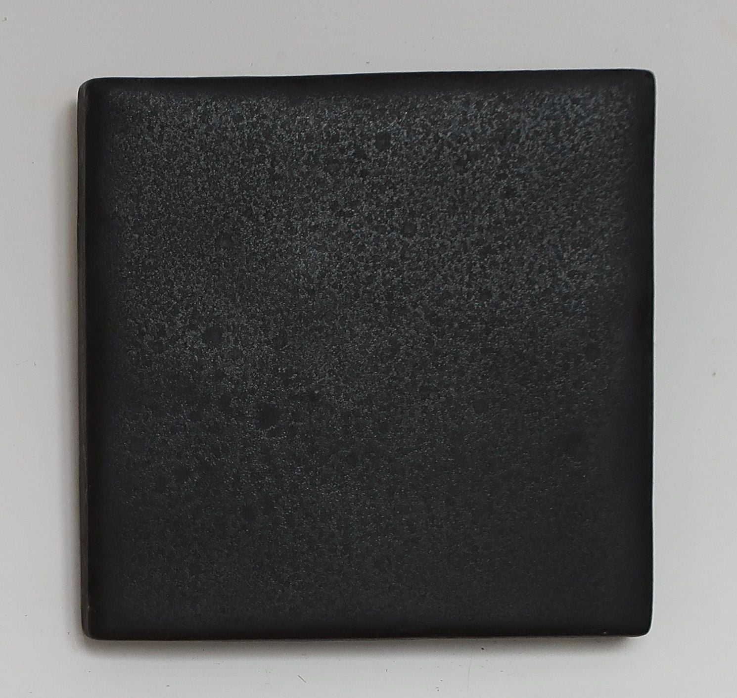 EQUIS black square sculpture mirror by ORRE Studio showing textured surface detail