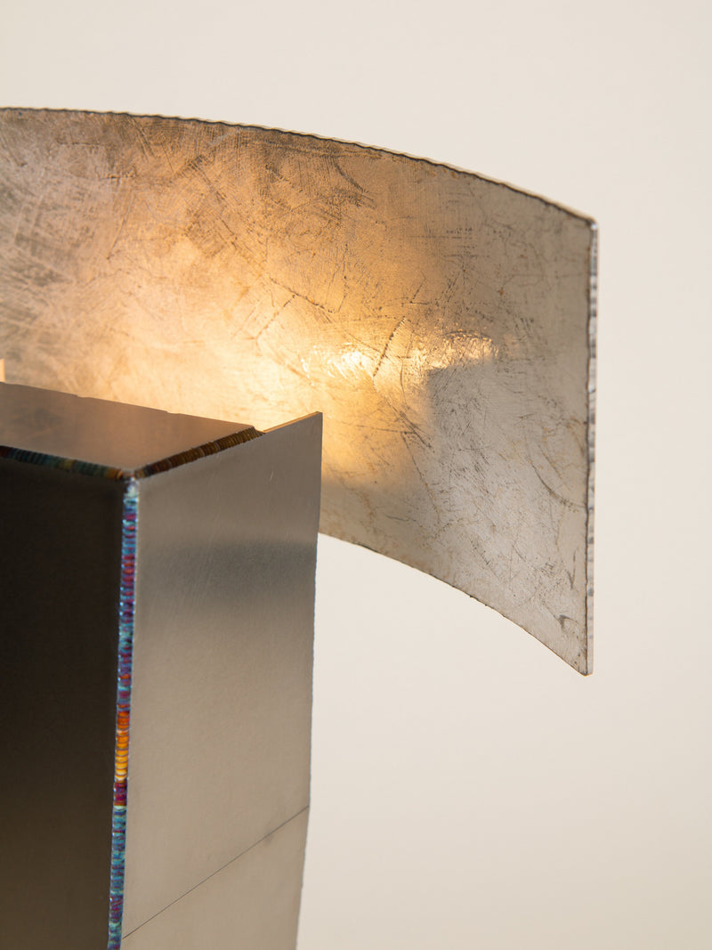 Objects of Function No.2305 — close-up of metallic lamp shade illuminating