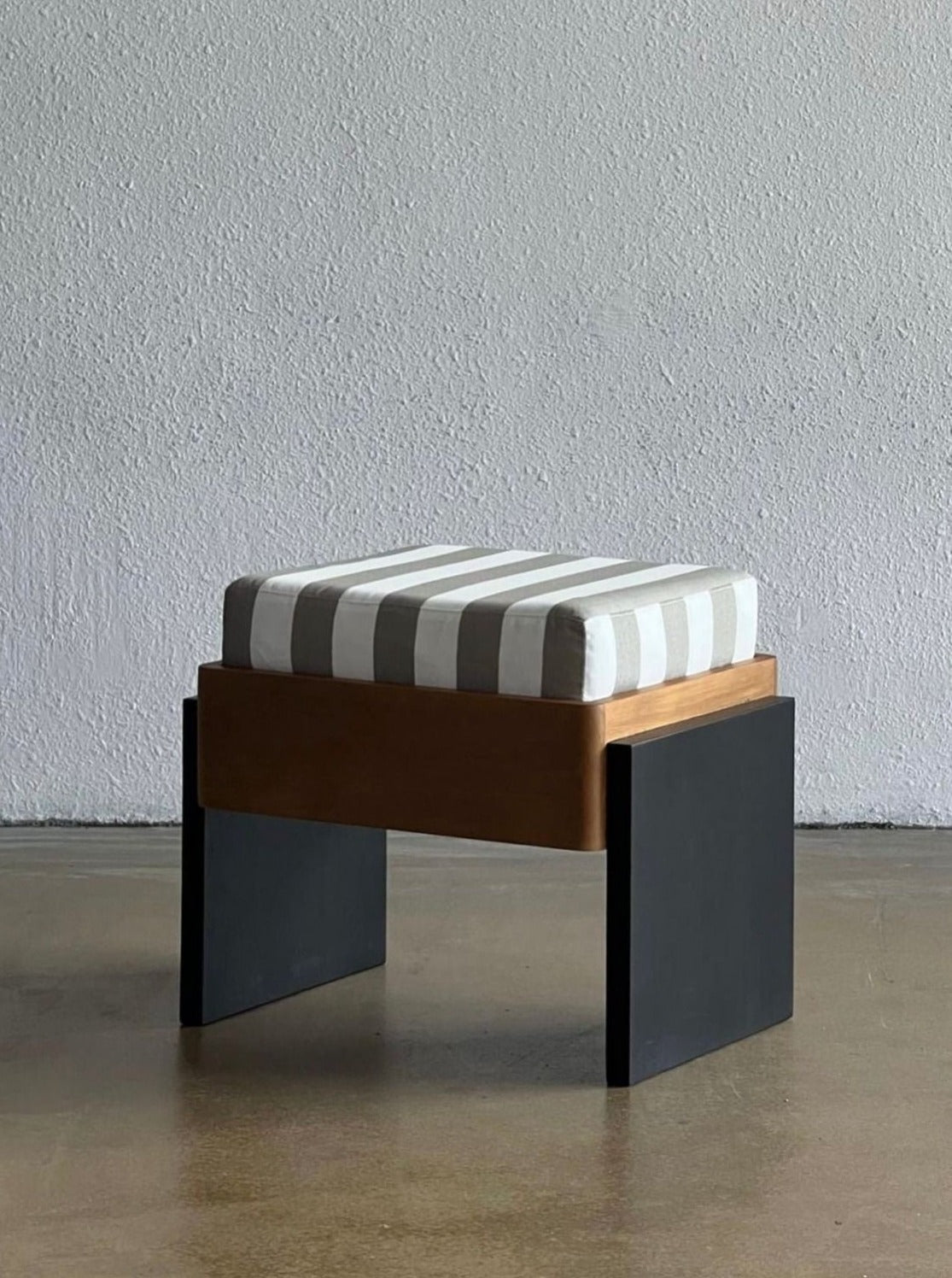Striped Ottoman — angled view highlighting wooden frame and striped cushion