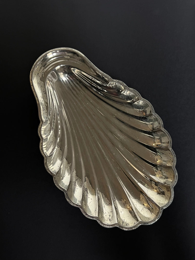 Silver shell-shaped decorative dish with ribbed surface design