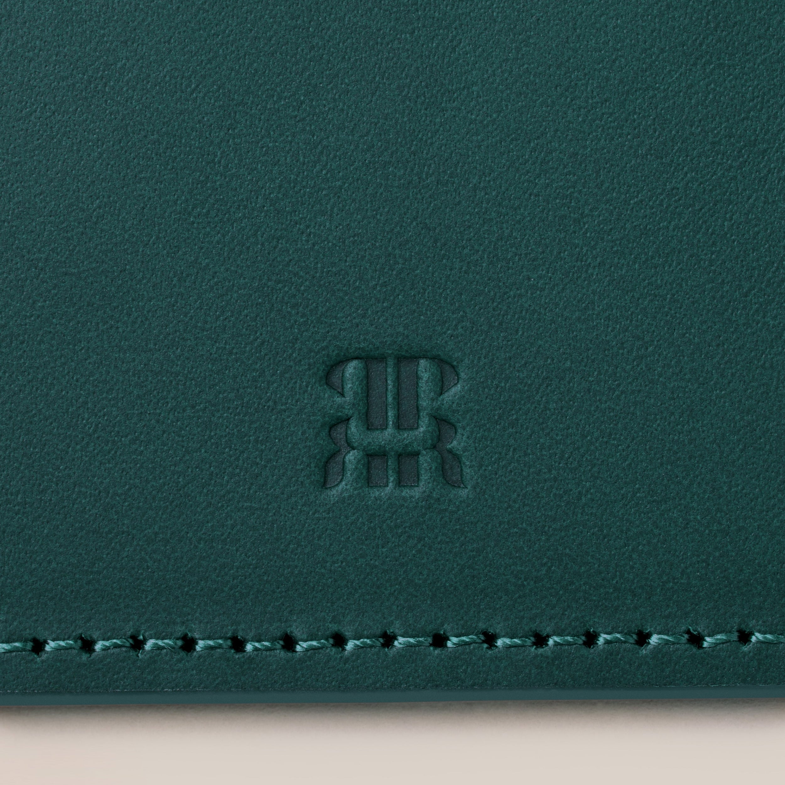 Leather Passport Holder — close-up of textured green leather surface