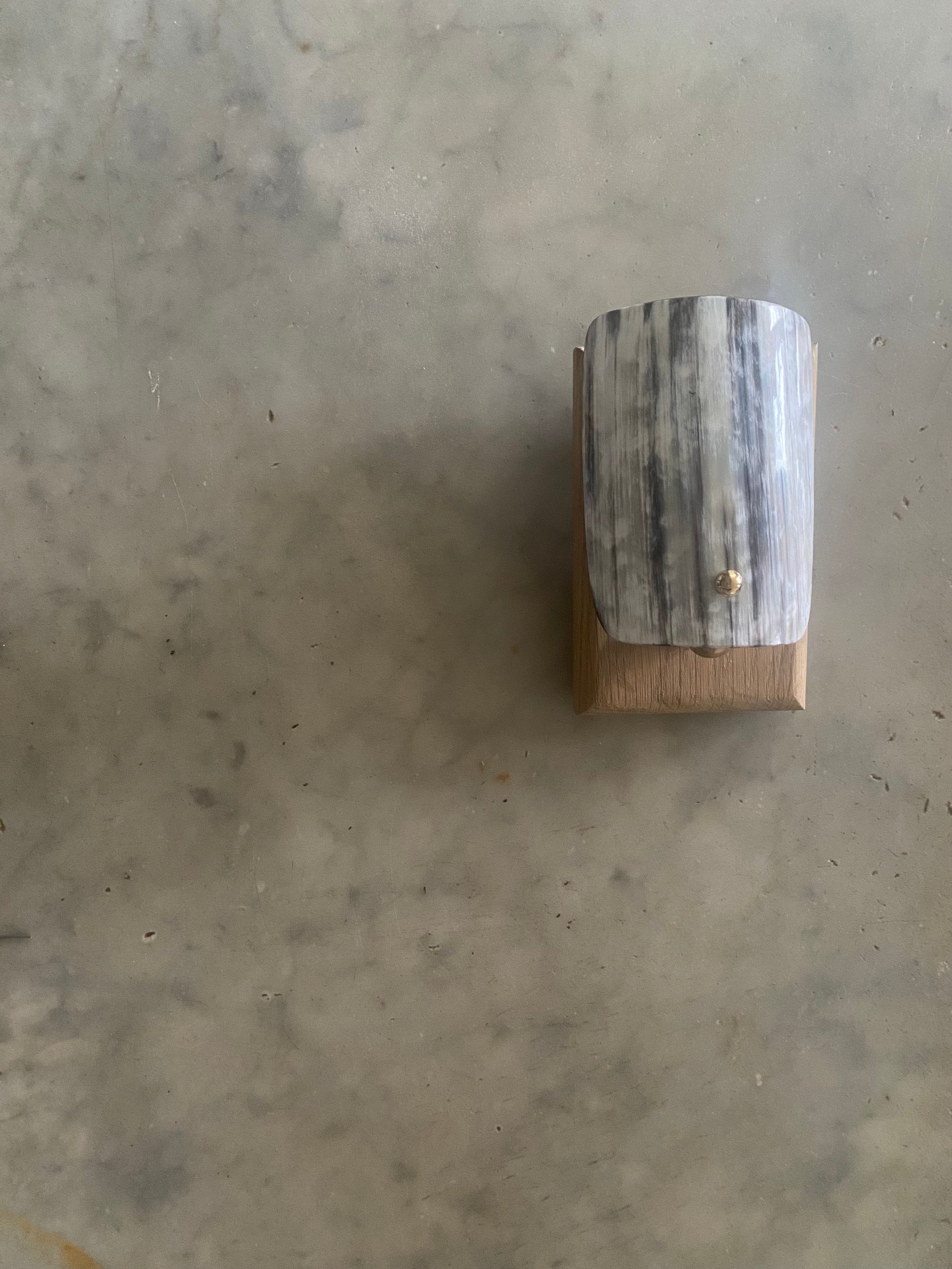 Arts and Crafts Wall Light in Oak and Horn - Horn Stud Collection — overhead view on textured surface